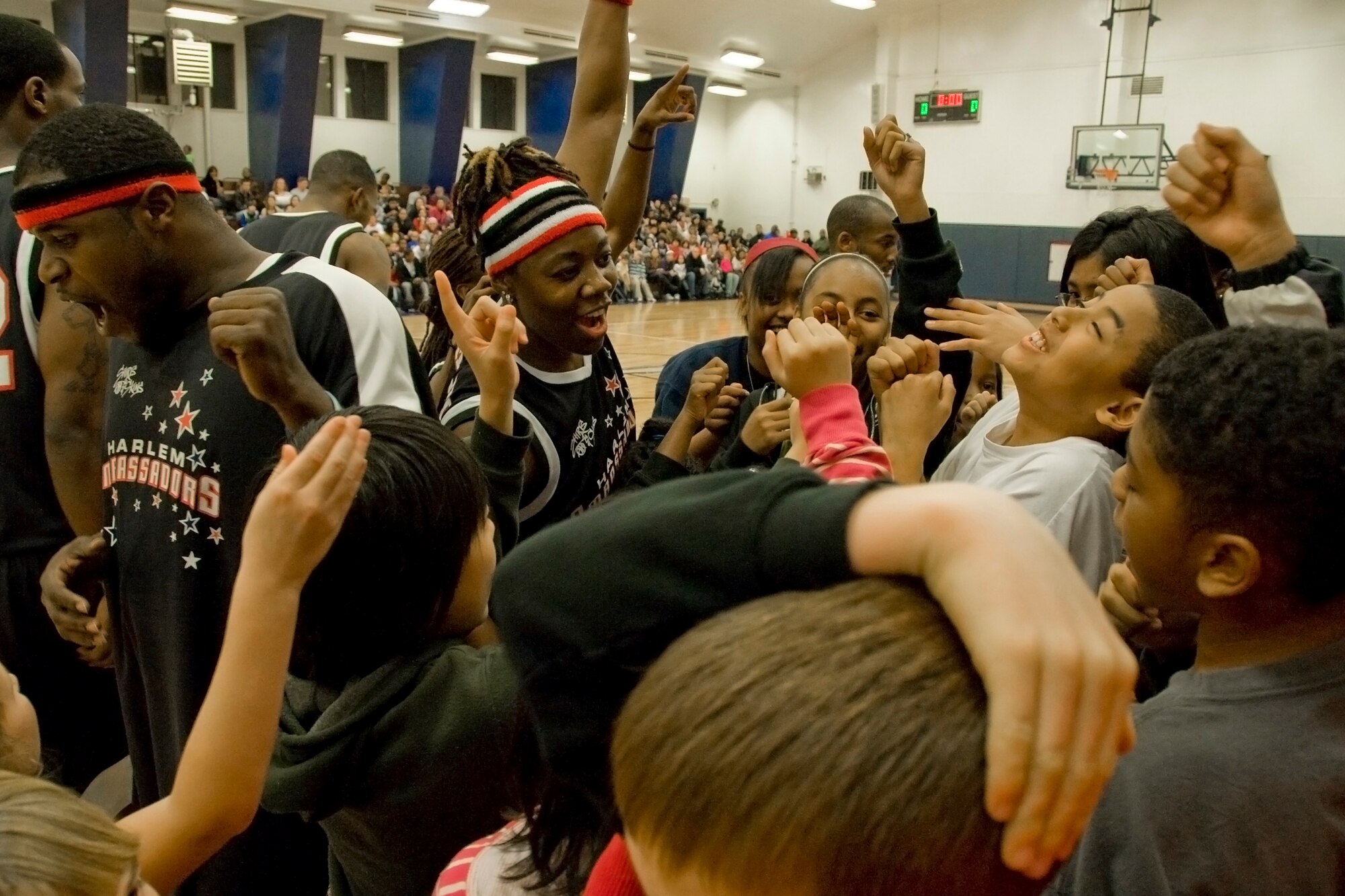 MISAWA AIR BASE, Japan -- Members of the Harlem Ambassadors lead children in a chant Dec. 7 at the Potter Fitness Center. According to their website, the mission of the Harlem Ambassadors is to deliver a quality basketball show to audiences throughout the United States and internationally. They have performed more than 300 shows at more than 150 different bases in all branches of military service. (U.S. Air Force photo/Senior Airman Jamal D. Sutter)