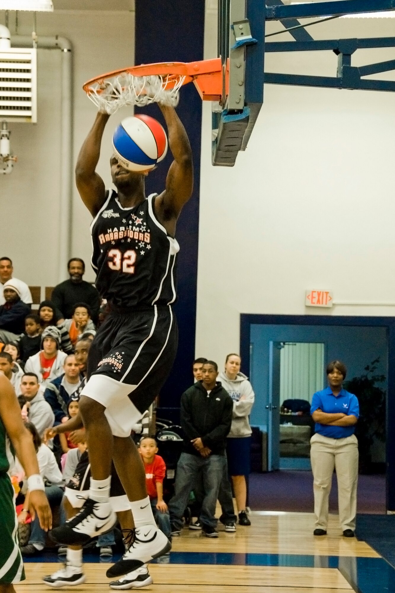 MISAWA AIR BASE, Japan -- Sam Givens, rookie forward for the Harlem Ambassadors, dunks during a basketball game against the Misawa Jets Dec. 7 at the Potter Fitness Center. The event showcased high-flying dunks, tricks and comedy skits. The team also played games with children and interacted with the audience. (U.S. Air Force photo/Senior Airman Jamal D. Sutter)
