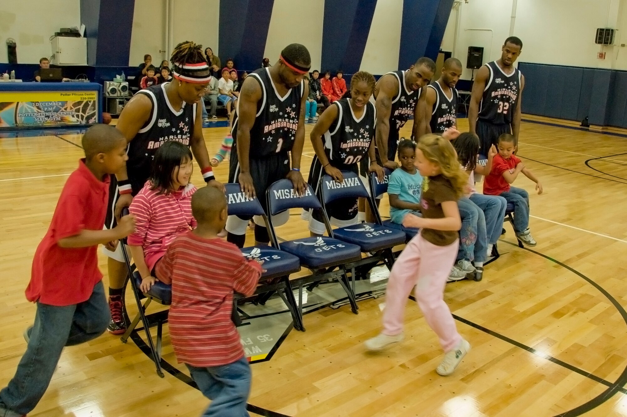 MISAWA AIR BASE, Japan -- Members of the Harlem Ambassadors lead children in a game of musical chairs Dec. 7 at the Potter Fitness Center. In addition to providing entertainment, the team encouraged the importance of education and being good role models. (U.S. Air Force photo/Senior Airman Jamal D. Sutter)