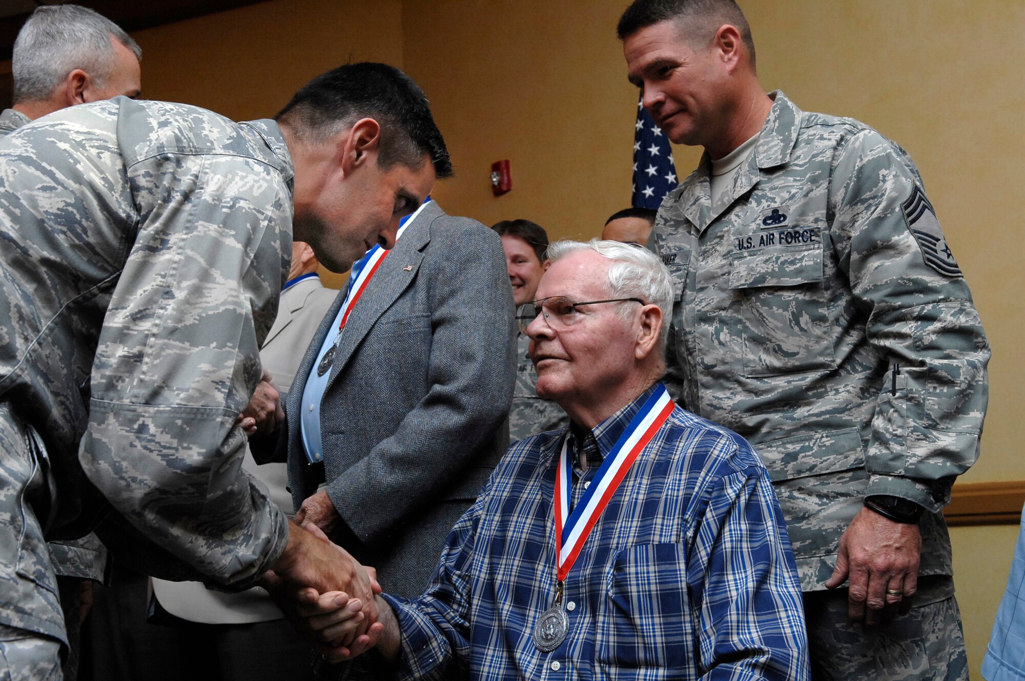 Col. Steven Basham, commander of the 2d Bomb Wing, greets Chief Master Sgt. (Ret.) Bobby Fife, a Charter Chief, during a luncheon Dec. 1. The luncheon was part of a series of events commemorating the 50th anniversary of the first Airmen to be promoted to chief master sergeant. (U.S. Air Force photo by Senior Airman Ryan Ivacic)