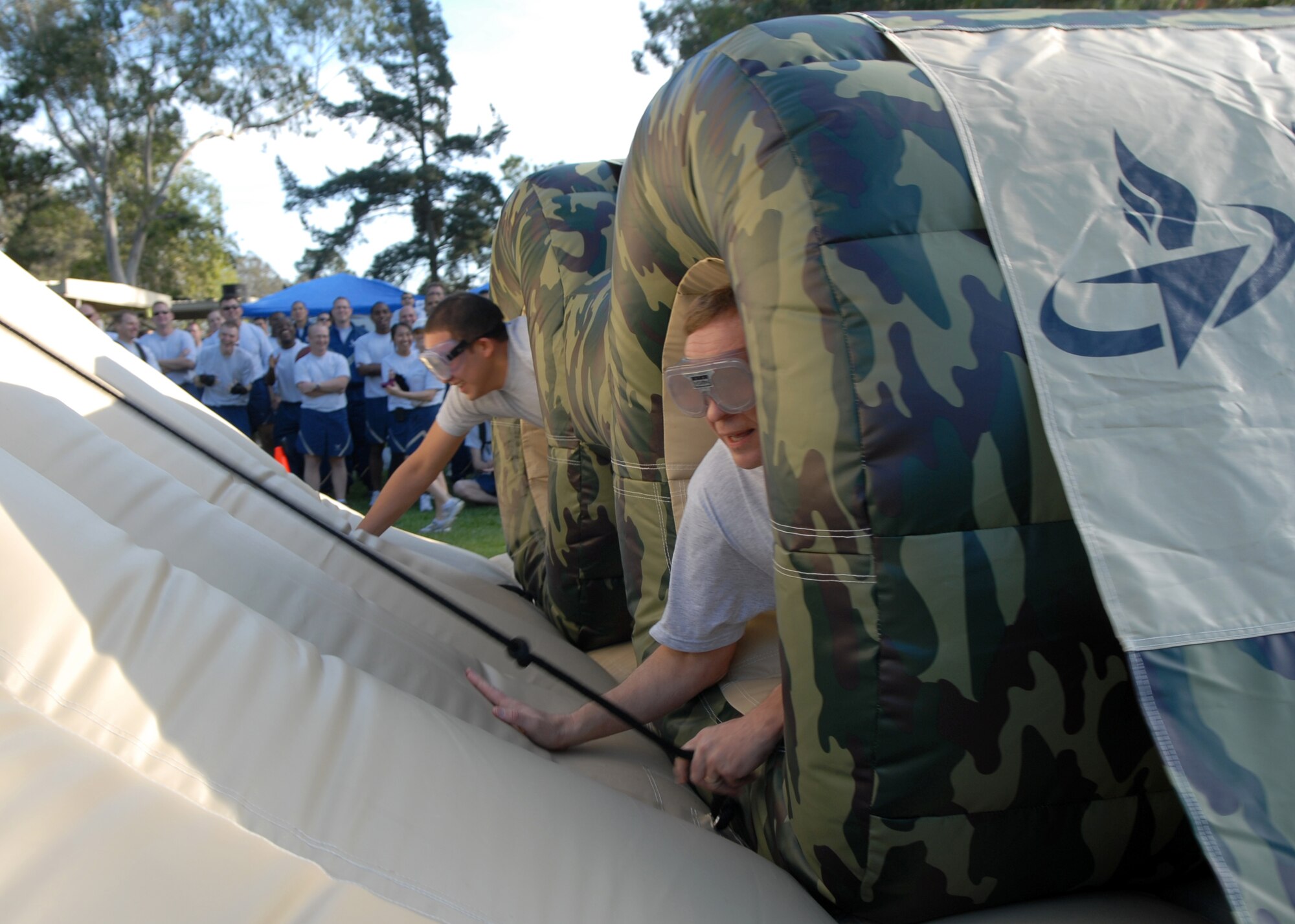 VANDENBERG AIR FORCE BASE, Calif. -- Airman Basic Omar Avila, a member of the 30th Civil Engineer Squadron, competes against Col. David Buck, the 30th Space Wing commander while wearing “drunk goggles” during Vandenberg’s annual Wingman Day Friday, Dec. 4, 2009, at Cocheo Park here. “Drunk goggles” were used to simulate a person’s visual impairment after 10 to12 drinks. (U.S. Air Force photo/Airman 1st Class Kerelin Molina)