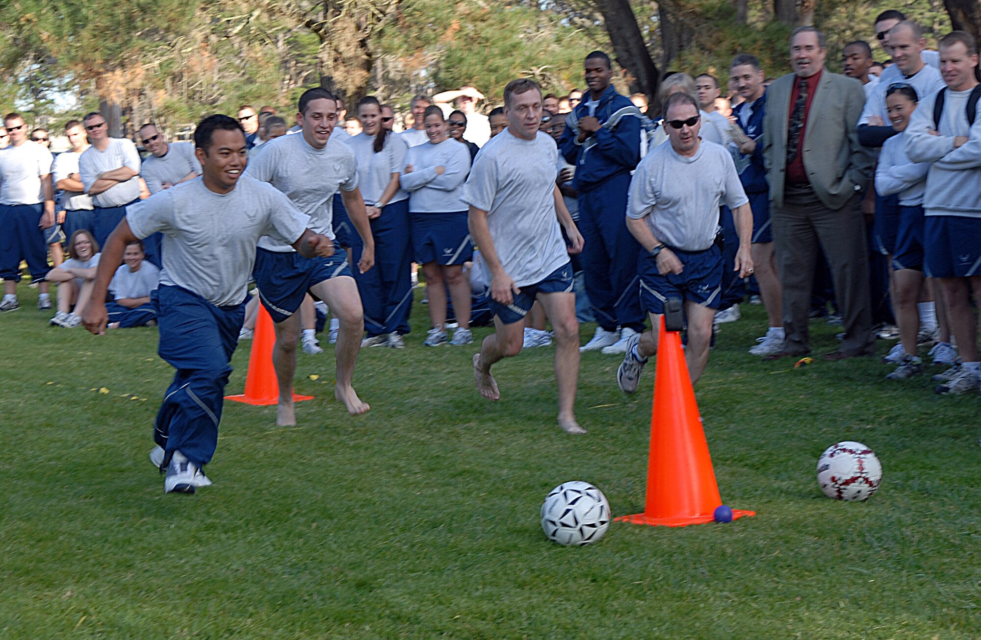 VANDENBERG AIR FORCE BASE, Calif. -- Kicking off  Vandenberg’s annual Wingman Day, the 30th Space Wing’s two youngest Airmen face off against its two most senior officers in an obstacle course challenge Friday, Dec. 4, 2009 here at Cocheo Park. Airman 1st Class Cid Bartolome and Airman Basic Omar Avila, members of the 30th Civil Engineer Squadron, compete against Col. David Buck, the 30th SW commander, and Col. Steven Winters the 30th SW vice commander, the challenge consisted of two laps around the obstacle course with the participants running one lap while wearing “drunk goggles”. (U.S. Air Force photo/Airman 1st Class Kerelin Molina)