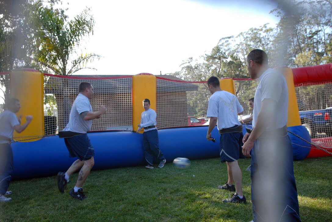 VANDENBERG AIR FORCE BASE, Calif. -- Members from the 14th Air Force and 30th Space Wing participate in a human foosball competition during Vandenberg’s annual Wingman Day Friday, Dec. 4, 2009, at Cocheo Park here. "The Wingman concept is more than just an event; it's a culture focused on Airmen taking care of Airmen 24/7, 365 days a year," said Maj. Jennifer Vecchione, the event coordinator. (U.S. Air Force photo/Airman 1st Class Kerelin Molina)
