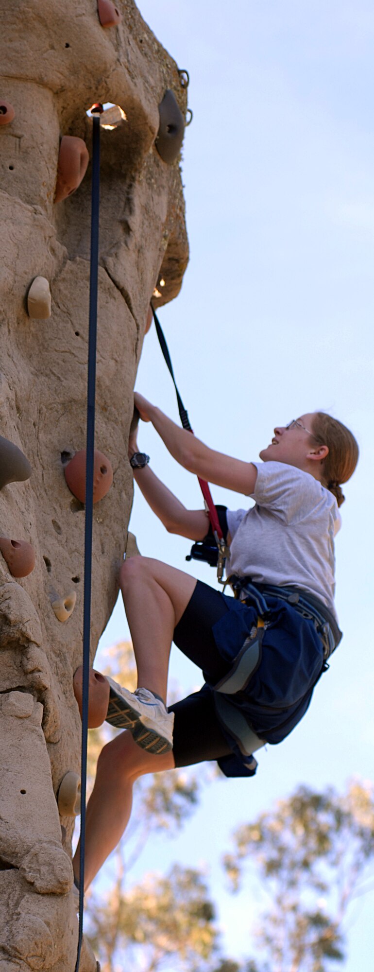 VANDENBERG AIR FORCE BASE, Calif. -- Airman 1st Class Danielle Graham, a member of the 30th Space Communications Squadron, looks for the next finger hole while on the rock climbing wall at Vandenberg’s annual Wingman Day on Friday, Dec. 4, 2009, at Cocheo Park here. Wingman Day offered various activities such as a human foosball competition, obstacle course and entertainment. (U.S. Air Force photo/Airman 1st Class Kerelin Molina)