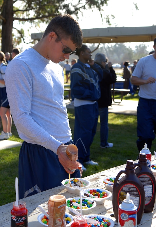 VANDENBERG AIR FORCE BASE, Calif. -- Browsing through the wide selection of toppings, 1st Lt. Brian Crouse, a member of the 1st Air and Space Training Squadron, enjoys some ice cream during Vandenberg’s annual Wingman Day on Friday, Dec. 4, 2009, at Cocheo Park here. "The success of the day rests on engaging with other Airmen and placing special emphasis on the importance of identifying risk factor behavior," said Maj. Jennifer Vecchione, the event coordinator. (U.S. Air Force photo/Airman 1st Class Kerelin Molina)