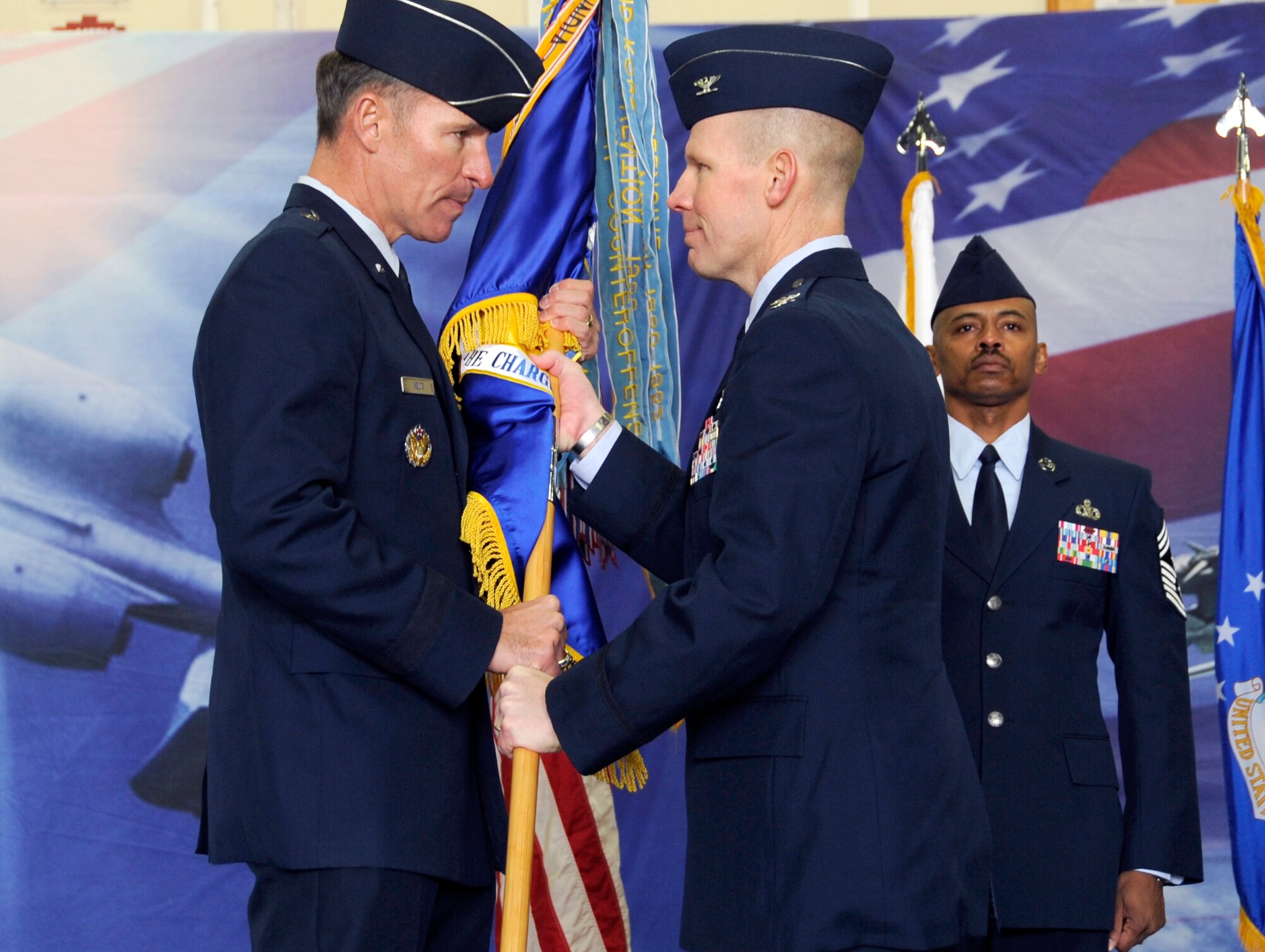 Brig. Gen. Michael Keltz, 7th Air Force Vice Commander, passes the guidon of the 51st Fighter Wing to Col. Patrick C. Malackowski, signifying his assumption of command during a change of command ceremony at Osan Air Base, Republic of Korea, Dec. 7.  Colonel Malackowski comes to Osan AB from Nellis Air Force Base, Nevada, where he was the 57th Operations Group Commander. (U.S. Air Force photo/Senior Airman Stephenie Wade)
