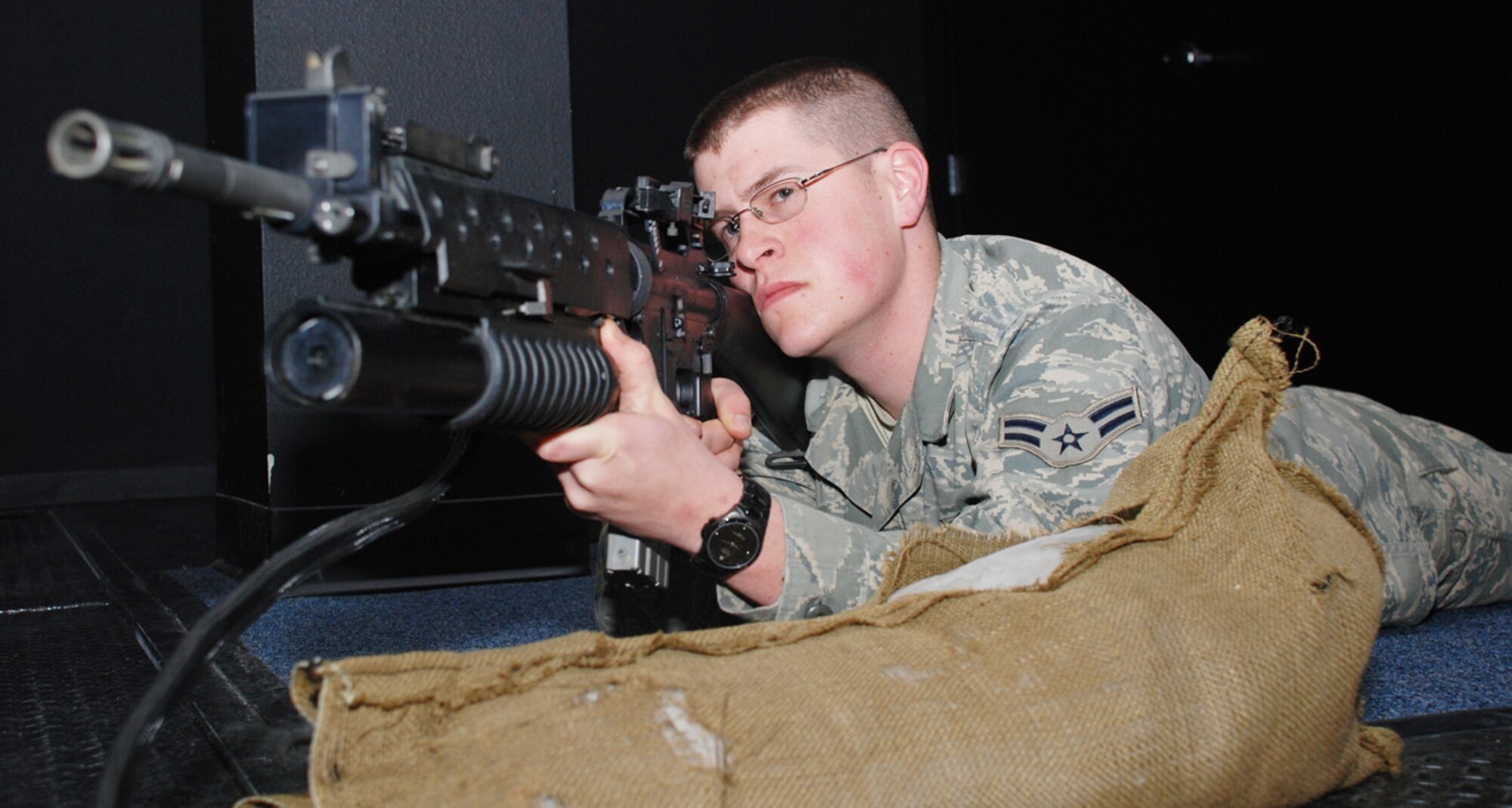 Airman 1st Class Timothy Johnson, 790th Missile Security Forces Squadron, aims his weapon at the screen during a session at the firearm training simulator March 10. Airmen within the 790th MSFS practiced their accuracy during the training.