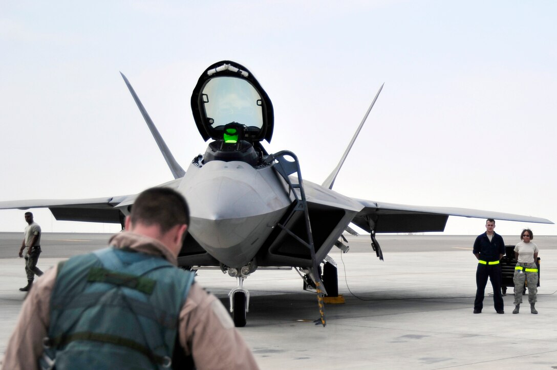Capt. Matthew Howard, 1st Fighter Wing pilot, prepares to board an F-22 Raptor Nov. 30, 2009, at an airfield in Southwest Asia. Captain Howard is participating in the Iron Falcon exercise while on temporary duty from Langley Air Force Base, Va. He is from Warrensburg, Mo. (U.S. Air Force photo/Tech. Sgt. Charles Larkin Sr)