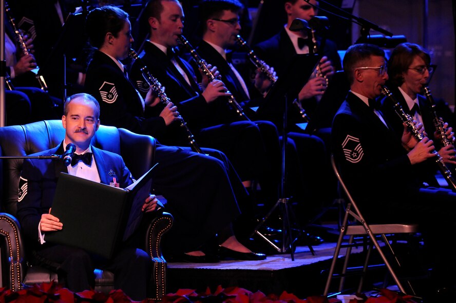 Master Sgt. Philip E. Krzywicki, United States Air Force Band, reads from the book Polar Express Dec. 5 during the holiday concert series "Hooray for the Holidays" at the Daughters of the American Revolution Constitution Hall, Washington, D.C. This year's series featured members of the Concert Band and Singing Sergeants in a musical presentation, highlighting holiday selections from stage and screen. The final installment of the holiday series will be at Centennial High School in Ellicott City,
Md., Dec 8. For more information on the USAF Band, visit www.usafband.af.mil. (U.S.
Air Force photo by Staff Sgt. Tim Chacon)
