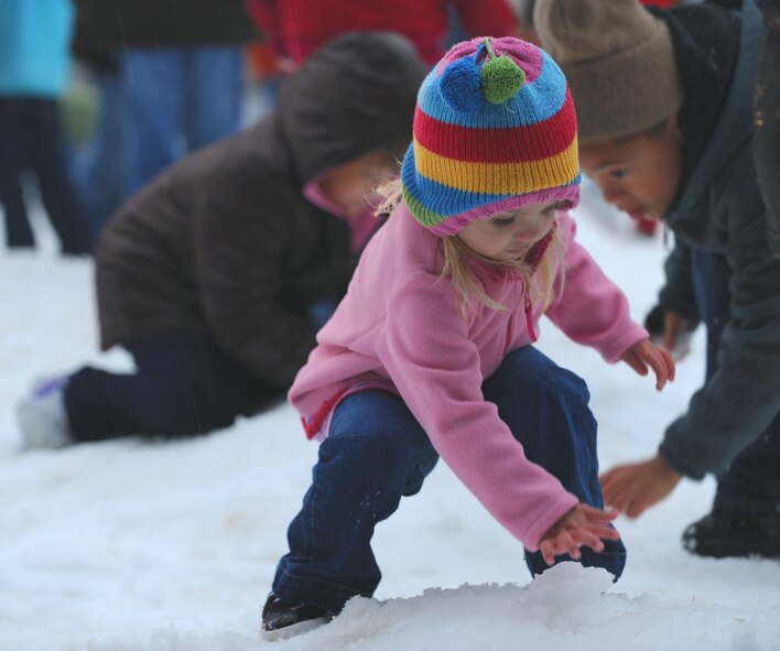 MOODY AIR FORCE BASE, Ga. -- Riley Gale, daughter of Tech. Sgt. Zachary Gale, 23rd Equipment Maintenance Squadron unit training manager, plays in the snow during the annual tree lighting ceremony here Dec. 4. . (U.S. Air Force photo by Airman 1st Class Benjamin Wiseman)