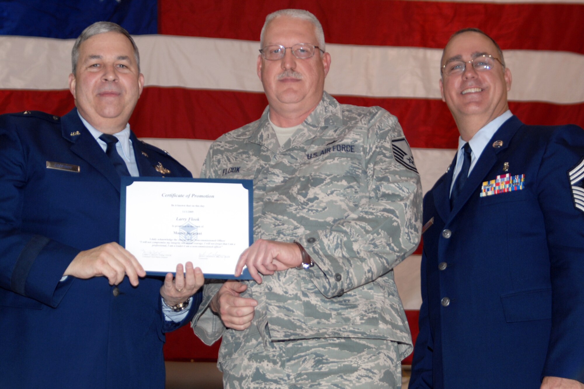 GRISSOM AIR RESERVE BASE, Ind., -- Brig. Gen. Dean Despinoy, 434th Air Refueling Wing commander, left, and Chief Master Sgt. Larry Brady, right, present a certificate to Master Sgt. Larry Flook, an expeditor with the 434th Aircraft Maintenance Squadron, recognizing his induction into the Senior NCO ranks. The presentation was made during a special ceremony in December. (U.S. Air Force photo/Tech. Sgt. Doug Hays)