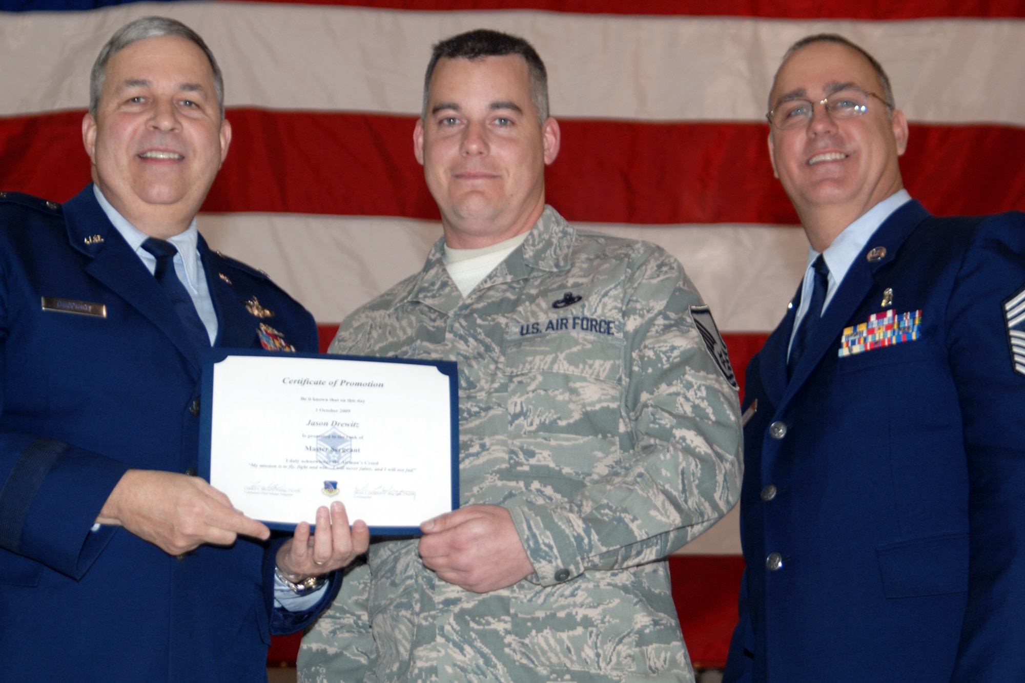 GRISSOM AIR RESERVE BASE, Ind., -- Brig. Gen. Dean Despinoy, 434th Air Refueling Wing commander, left, and Chief Master Sgt. Larry Brady, right, present a certificate to Master Sgt. Jason Drewitz , a KC-135R Stratotanker crew chief with the 434th Maintenance Squadron, recognizing his induction into the Senior NCO ranks. (U.S. Air Force photo/Tech. Sgt. Doug Hays)