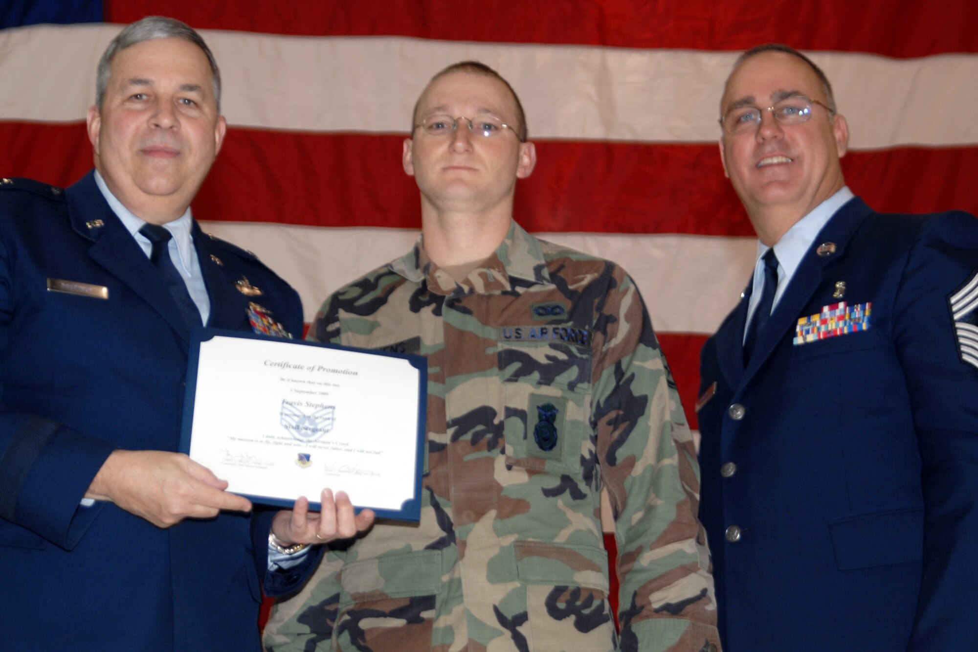 GRISSOM AIR RESERVE BASE, Ind., -- Brig. Gen. Dean Despinoy, 434th Air Refueling Wing commander, left, and Chief Master Sgt. Larry Brady, right, present a certificate to Staff Sgt. Travis Stephens, a fire team member with the 434th Security Forces Squadron, recognizing his induction into the NCO ranks. (U.S. Air Force photo/Tech. Sgt. Doug Hays)
