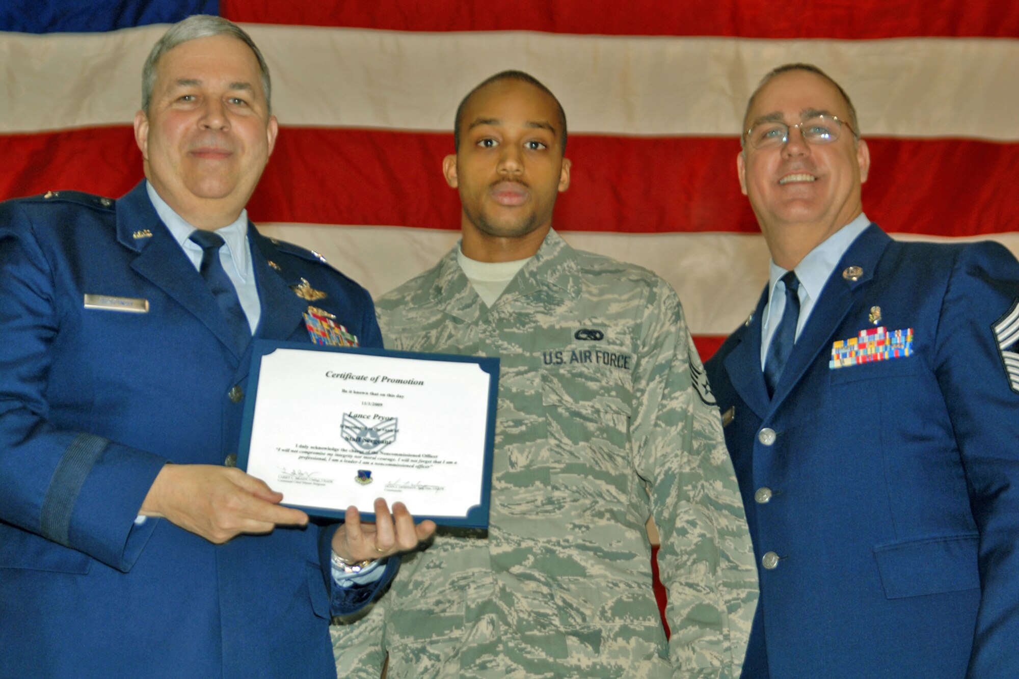 GRISSOM AIR RESERVE BASE, Ind., -- Brig. Gen. Dean Despinoy, 434th Air Refueling Wing commander, left, and Chief Master Sgt. Larry Brady, right, present a certificate to Staff Sgt. Lance Pryor, a jet engine mechanic with the 434th Aircraft Maintenance Squadron, recognizing his induction into the NCO ranks. (U.S. Air Force photo/Tech. Sgt. Doug Hays)