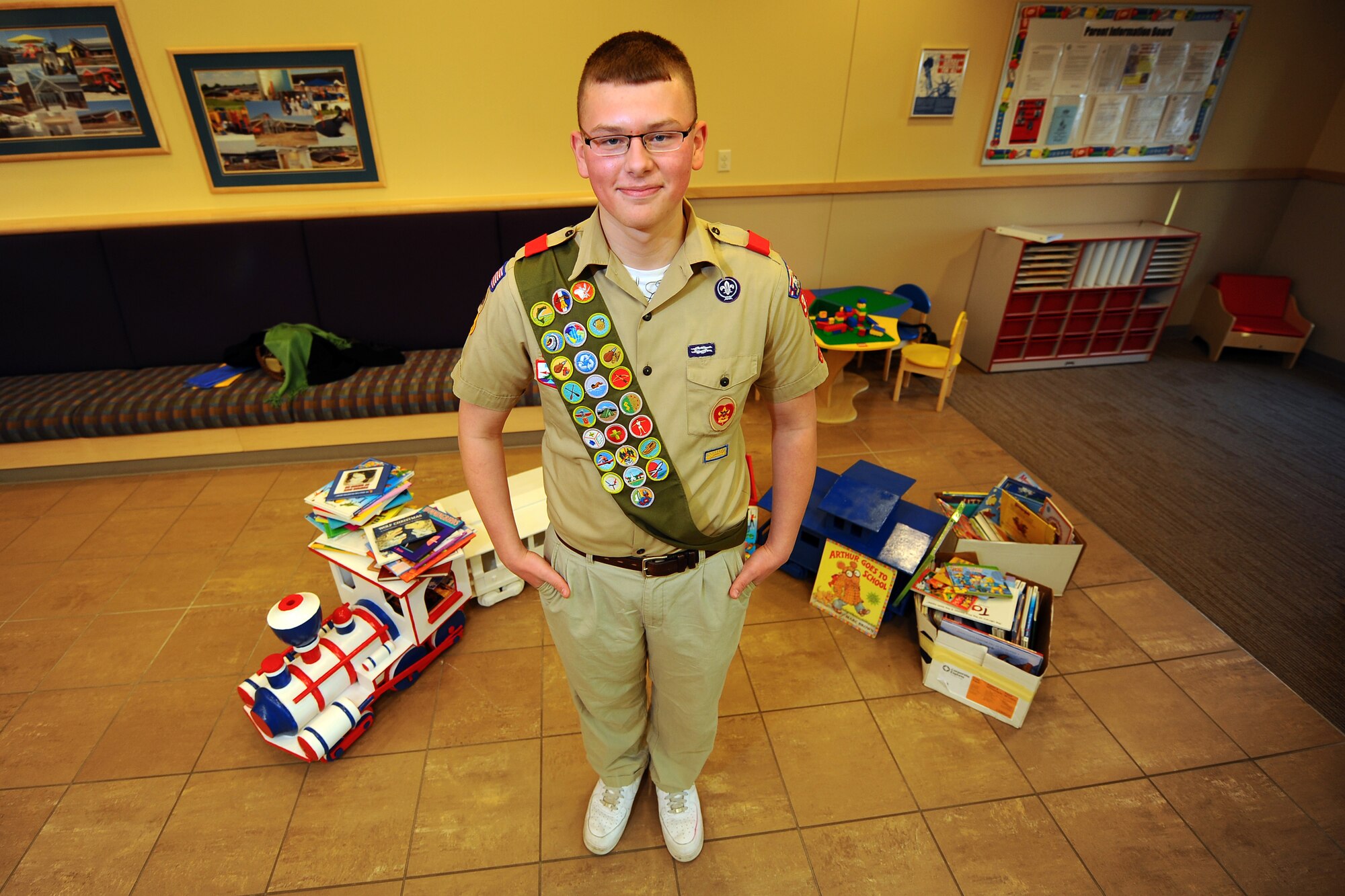 OFFUTT AIR FORCE BASE, Neb.- Josh Flott, from Boy Scout Troop 359, stands in front of a wooden train holding hundreds of donated books Dec. 4 that he spent a month putting together for children at one of the base's child development centers. The young man, a Papillion resident, has been in the Boy Scouts since he was in first grade and is hoping to have a career as an officer in the U.S. Air Force.

U.S. Air Force photo by Josh Plueger