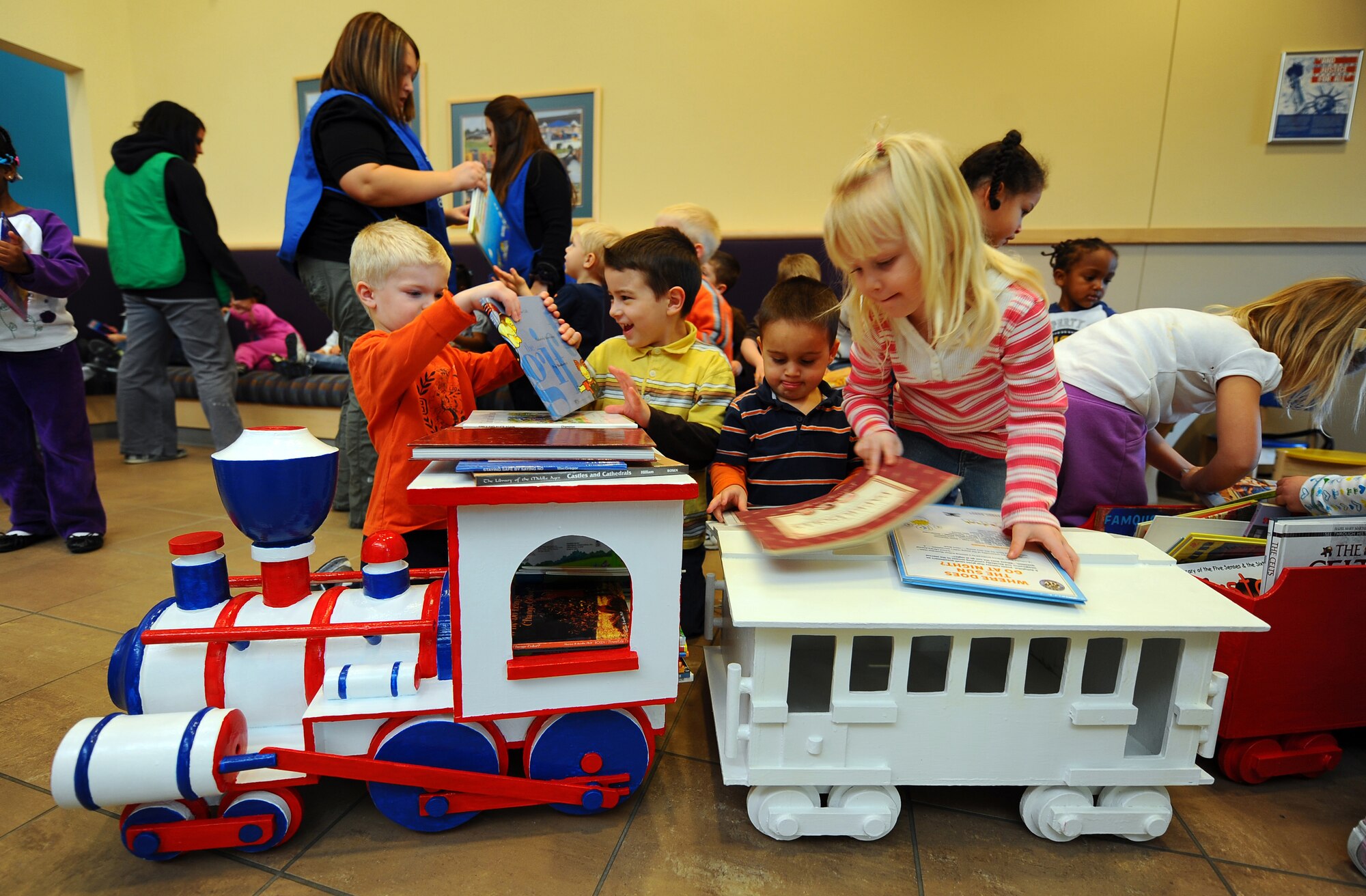 OFFUTT AIR FORCE BASE, Neb.- Eager children grab from a large selection of donated books displayed in a wooden train in one of the base child development centers Dec. 4.  Josh Flott, from Boy Scout Troop 359, spent about a month collecting the books and building the train he named Choo Choo for Children's Books.

U.S. Air Force photo by Josh Plueger