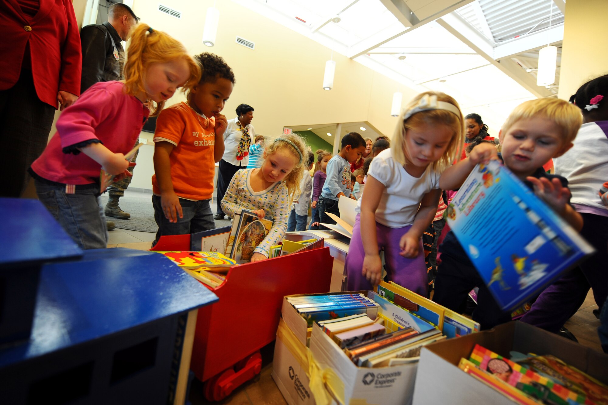 OFFUTT AIR FORCE BASE, Neb.- Eager children grab from a large selection of donated books displayed in a wooden train at one of the base child development centers Dec. 4.  Josh Flott, from Boy Scout Troop 359, spent about a month collecting the books and building the train he named Choo Choo for Children's Books.

U.S. Air Force photo by Josh Plueger
