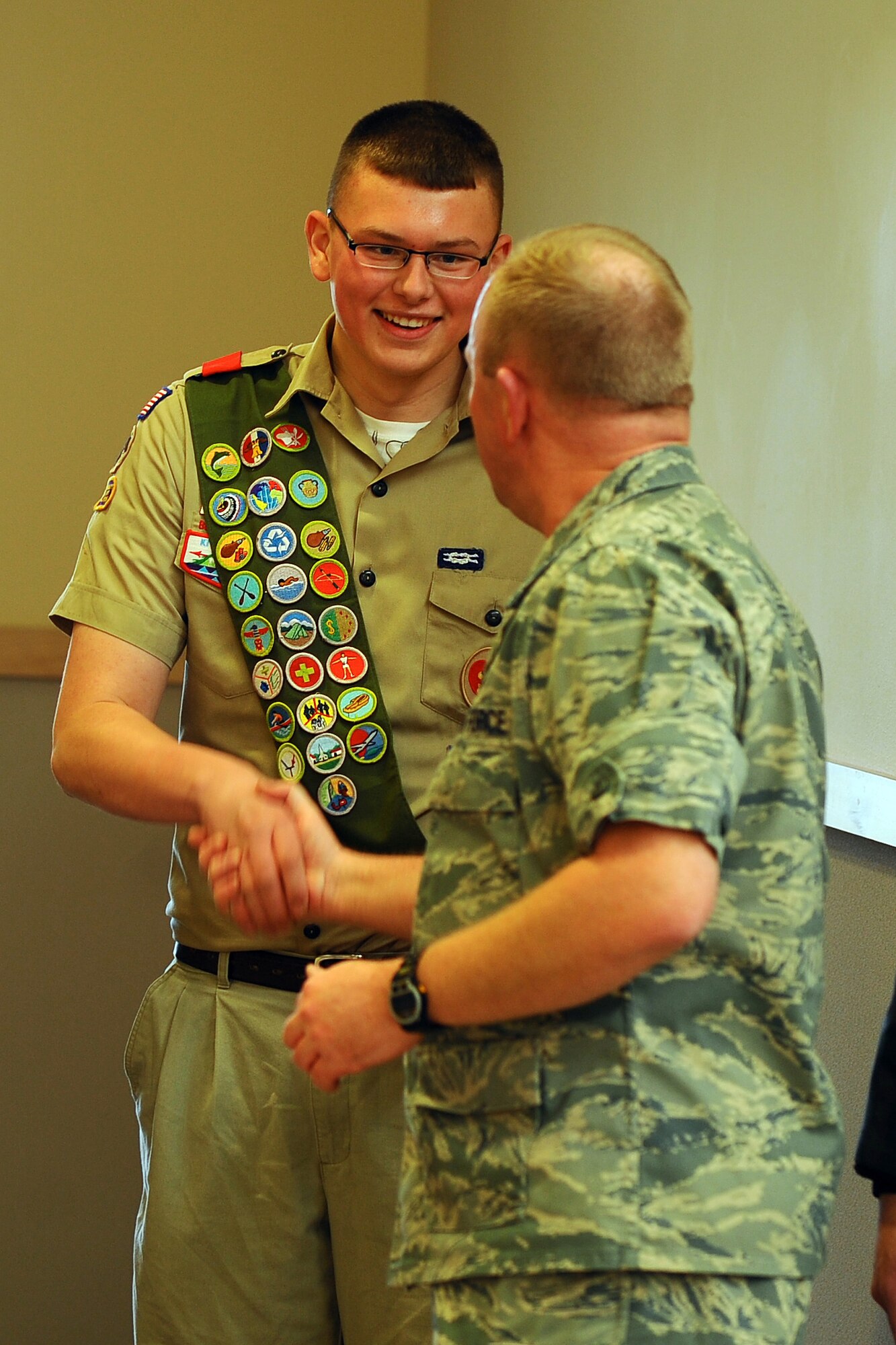 OFFUTT AIR FORCE BASE, Neb.- Boy Scout Josh Flott, a member of Troop 359, is given a coin by 55th Mission Supoort Group Commander Col. Michael J. Allshouse Dec. 4 for his gift of a large wooden train holding hundreds of donated books.  Mr. Flott spent about a month collecting the books and building the train he named Choo Choo for Children's Books that was given to the Child Development Center.

U.S. Air Force photo by Josh Plueger