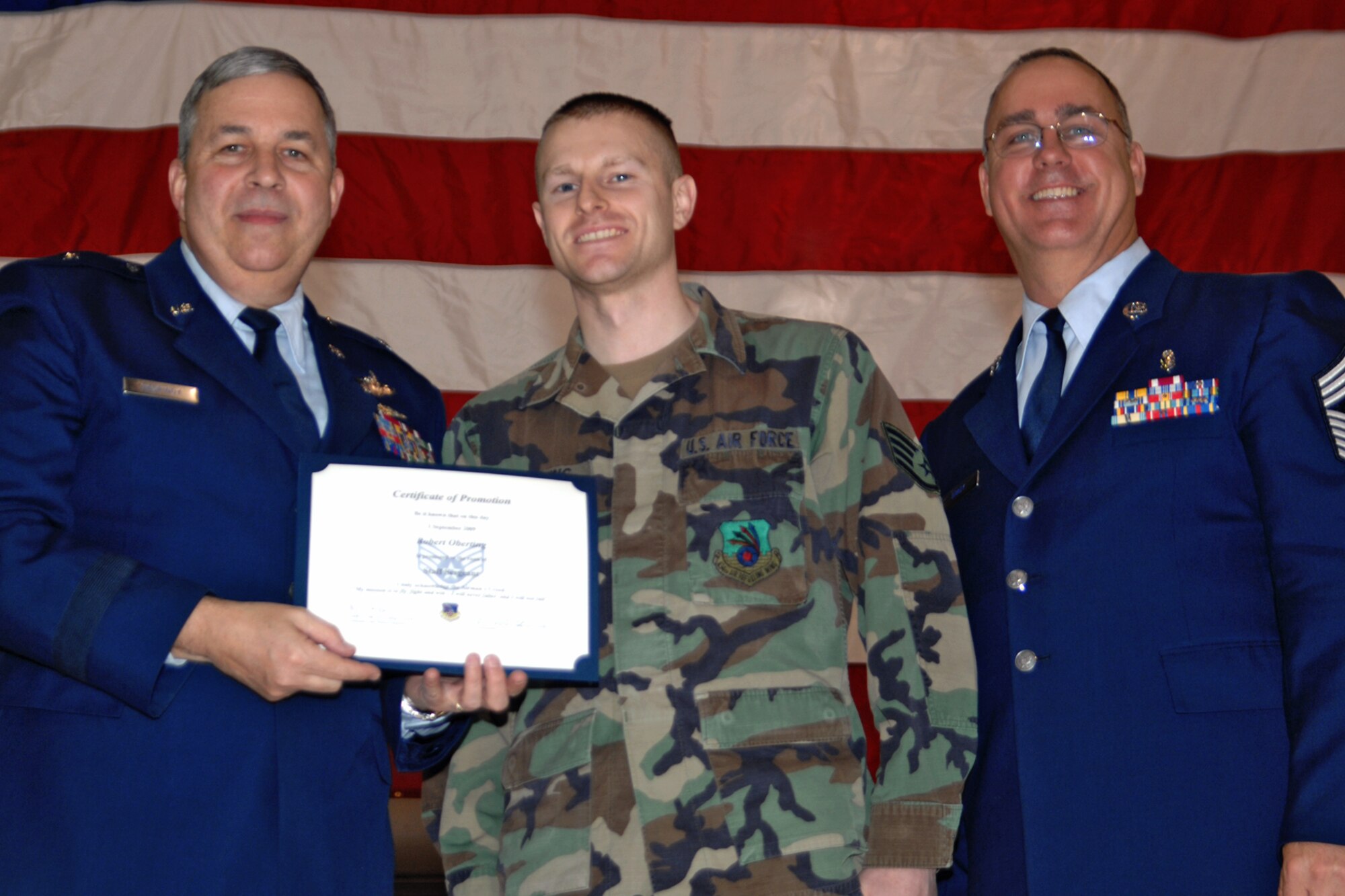 GRISSOM AIR RESERVE BASE, Ind., -- Brig. Gen. Dean Despinoy, 434th Air Refueling Wing commander, left, and Chief Master Sgt. Larry Brady, right, present a certificate to Staff Sgt. Robert Oberting, an nondestructive inspection journeyman with the 434th Maintenance Squadron, recognizing his induction into the NCO ranks. The presentation was made during a special ceremony.  (U.S. Air Force photo/Tech. Sgt. Doug Hays)