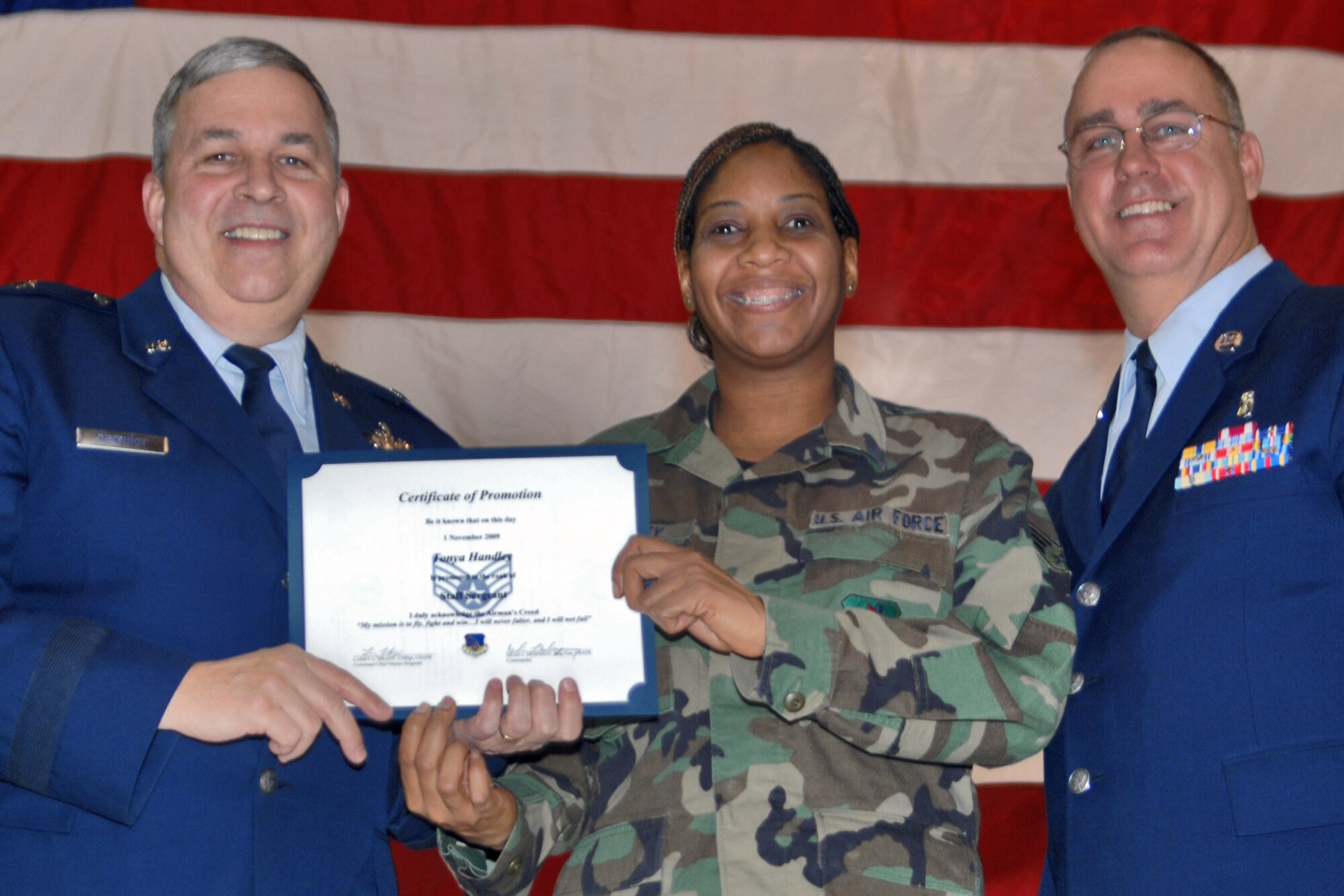 GRISSOM AIR RESERVE BASE, Ind., -- Brig. Gen. Dean Despinoy, 434th Air Refueling Wing commander, left, and Chief Master Sgt. Larry Brady, right, present a certificate to Staff Sgt. Tonya Handley, a medical material apprentice with the 434th Aerospace Medicine Squadron, recognizing her induction into the NCO ranks. The presentation was made during a special ceremony recognizing those who were recently promoted.  (U.S. Air Force photo/Tech. Sgt. Doug Hays)