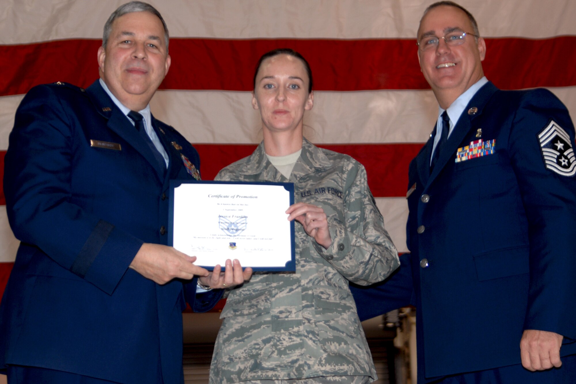 GRISSOM AIR RESERVE BASE, Ind., -- Brig. Gen. Dean Despinoy, 434th Air Refueling Wing commander, left, and Chief Master Sgt. Larry Brady, right, present a certificate to Staff Sgt. Jessica Franklin, a vehicle operator/dispatcher with the 434th Logistics Readiness Squadron, recognizing her induction into the NCO ranks. (U.S. Air Force photo/Tech. Sgt. Doug Hays)
