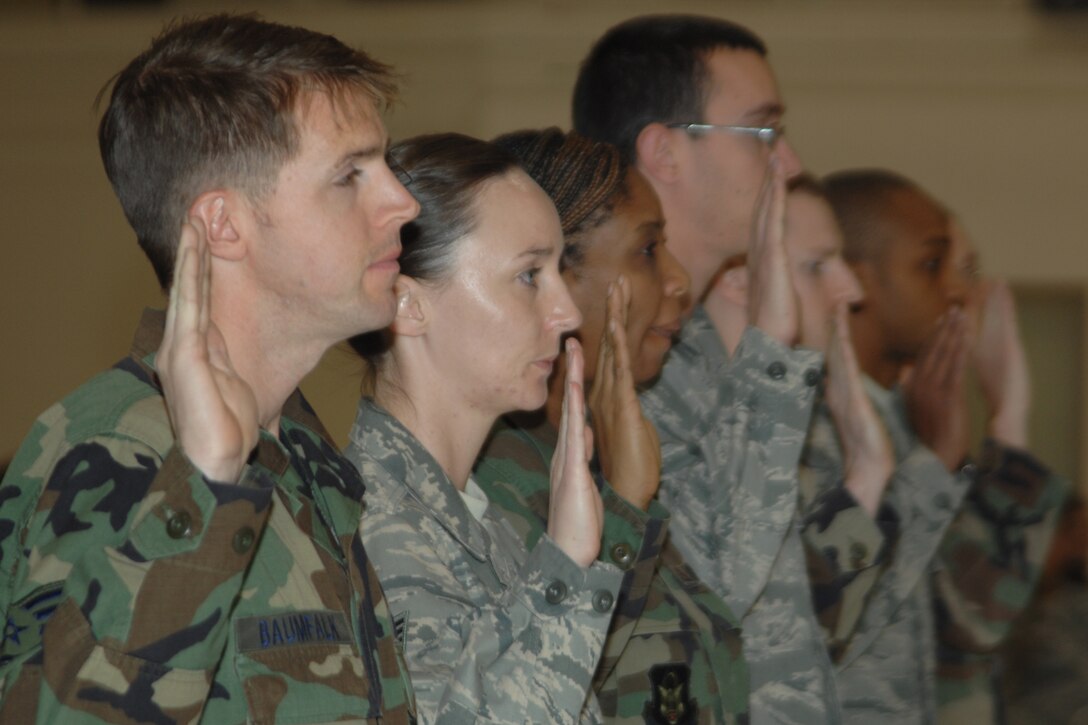 GRISSOM AIR RESERVE BASE, Ind., -- Grissom's newest NCOs raise their hand as they accept the charge given to them as noncommissioned officers. Grissom held an induction ceremony during the Decemeber Unit Training Assembly.  (U.S. Air Force photo/Tech. Sgt. Doug Hays)