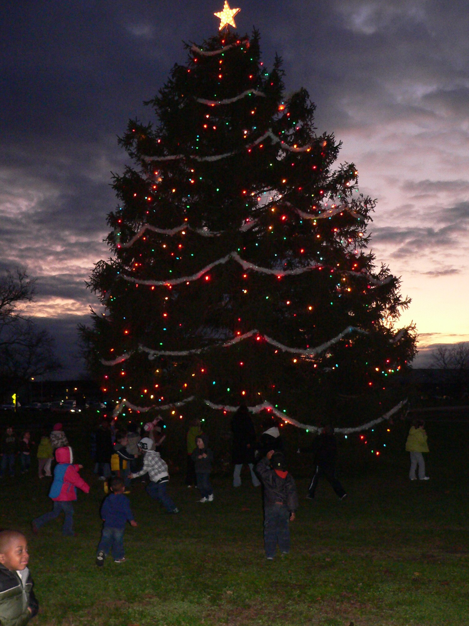 Children run enthusiastically to the holiday tree on Dix, Dec. 3. The tree lighting ceremony was followed by a visit from Santa Claus. (U.S. Air Force Photo/Stephen Snyder)