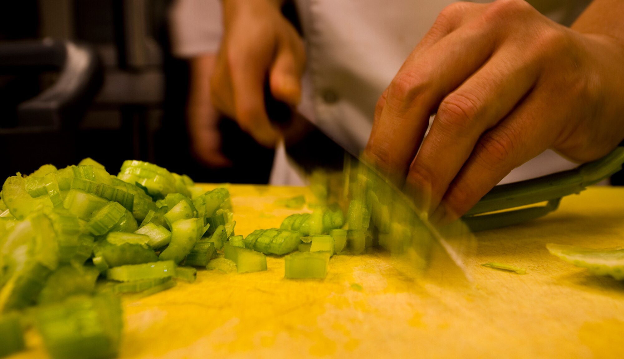 Fast-paced slicing and dicing with razor-sharp knives can lead to chopped fingers. Chef Nuval says avoid losing focus or ?showing off? to avoid a painful mishap. (photo by Tech. Sgt. Matthew Hannen)
