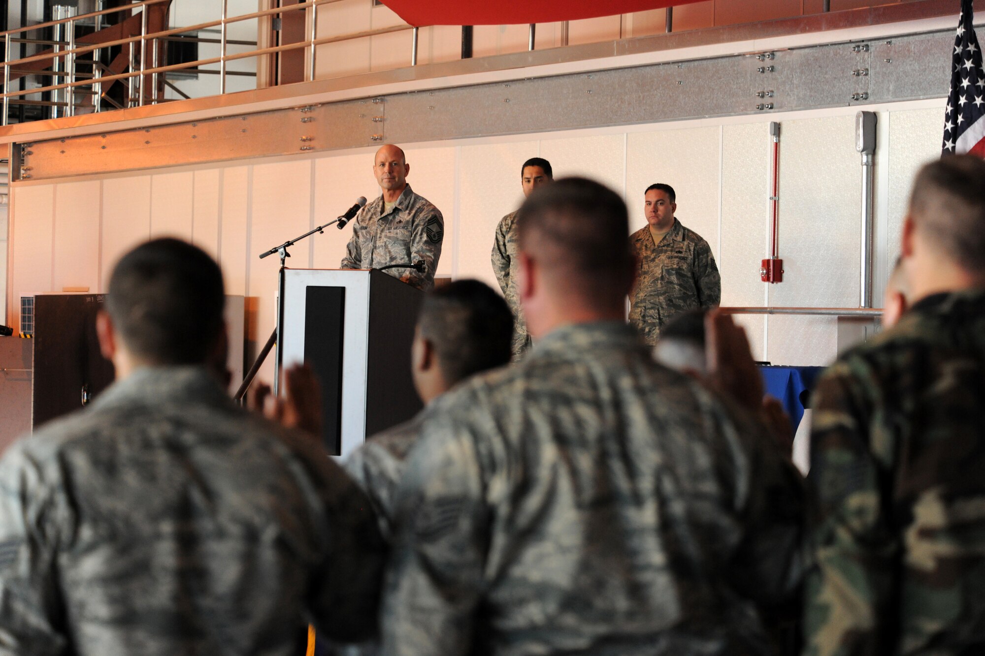 HOLLOMAN AIR FORCE BASE, N.M. -- Chief Master Sgt. Michael Hedum, 49th Aircraft Maintenance Squadron superintendant, gives the Dedicated Crew Chief Charter to 18 aircraft maintainers during a Dedicated Crew Chief Appointment Ceremony here Dec. 4. The dedicated crew chiefs, all from the 49th Aircraft Maintenance Squadron, are now responsible for all maintenance on their respective aircraft. (U.S. Air Force photo by Senior Airman Michael Means)