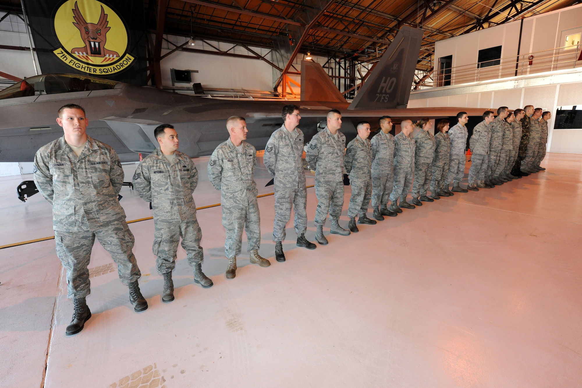 HOLLOMAN AIR FORCE BASE, N.M. -- Eighteen maintainers from the 49th Aircraft Maintenance Squadron stand in front an F-22A Raptor after each individual was given the title of dedicated crew chief during an appointment ceremony here Dec. 4. The dedicated crew chiefs, all from the 49th Aircraft Maintenance Squadron, are now responsible for all maintenance on their respective aircraft. (U.S. Air Force photo by Senior Airman Michael Means)