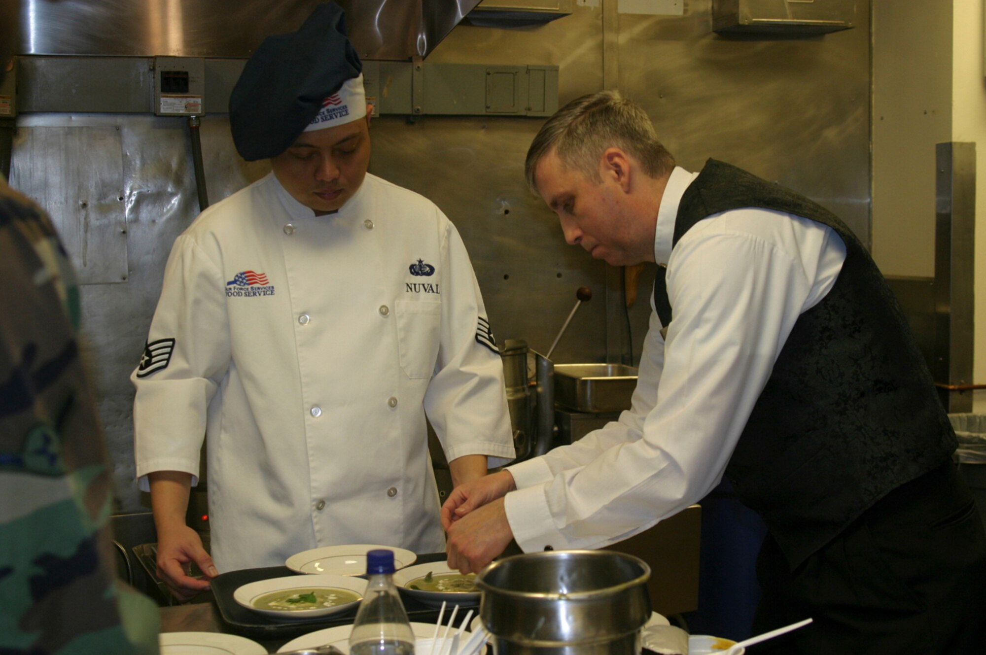 Serving as a sous-chef for Tech. Wesley Williams, Nuval and his mentor, shown here in 2007, made a dish that earned a spot on Emeril Live. This year, Nuval and his culinary team earned an award at the Military Culinary Competition in Washington D.C. Sept. 25. (Courtesy photo)