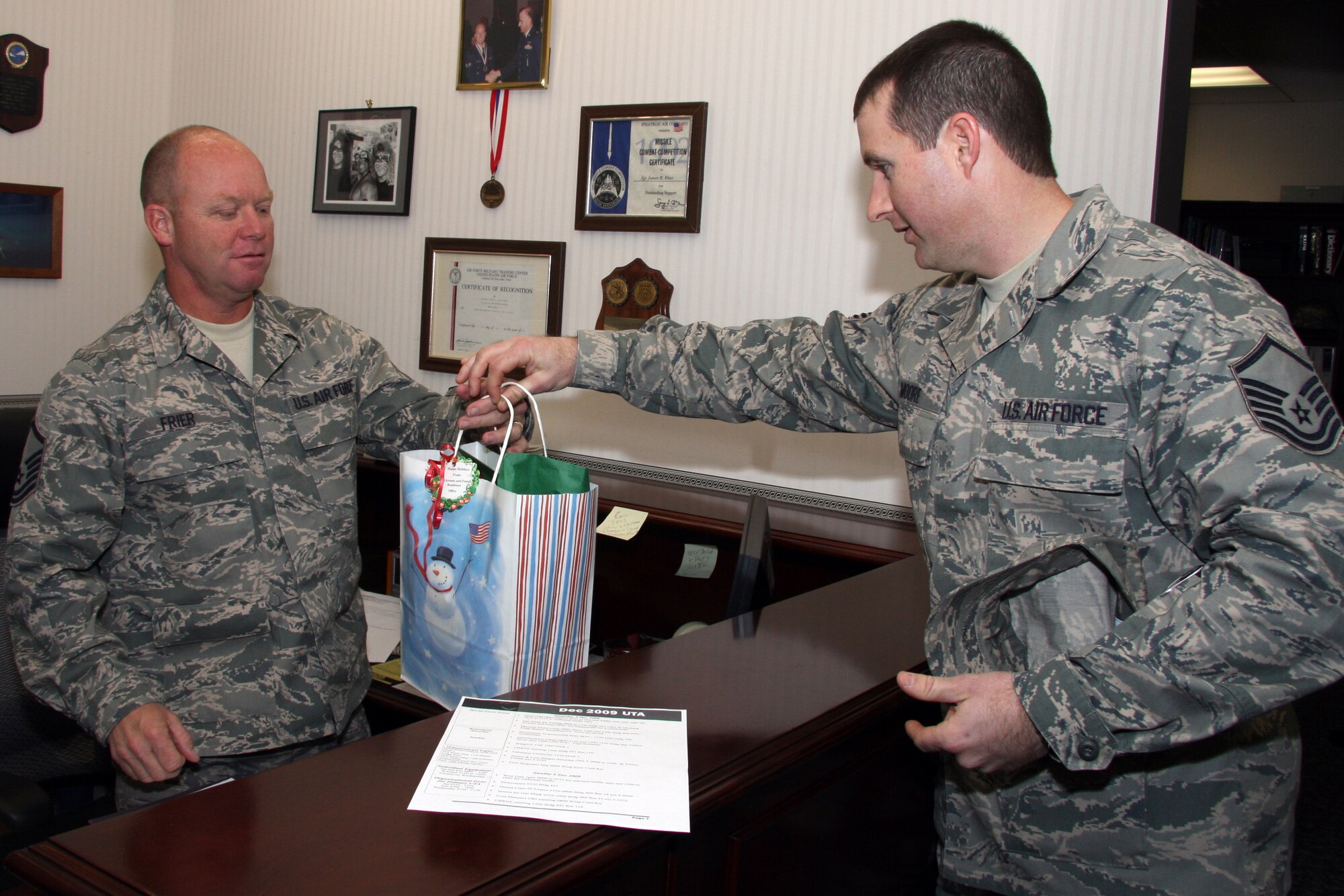 GRISSOM AIR RESERVE BASE, Ind. -- Master Sgt. Nathan Moore, 434th Airman and Family Readiness noncommissioned officer in charge, gives a holiday bag full of candy canes to Master Sgt. Jim Frier, Jr., 434th Air Refueling Wing information management technician. The Airman and Family Readiness office here gave out these holiday packages to each unit in celebration of the holiday season during the December unit training assembly. (U.S. Air Force photo/Tech. Sgt. Mark Orders-Woempner)