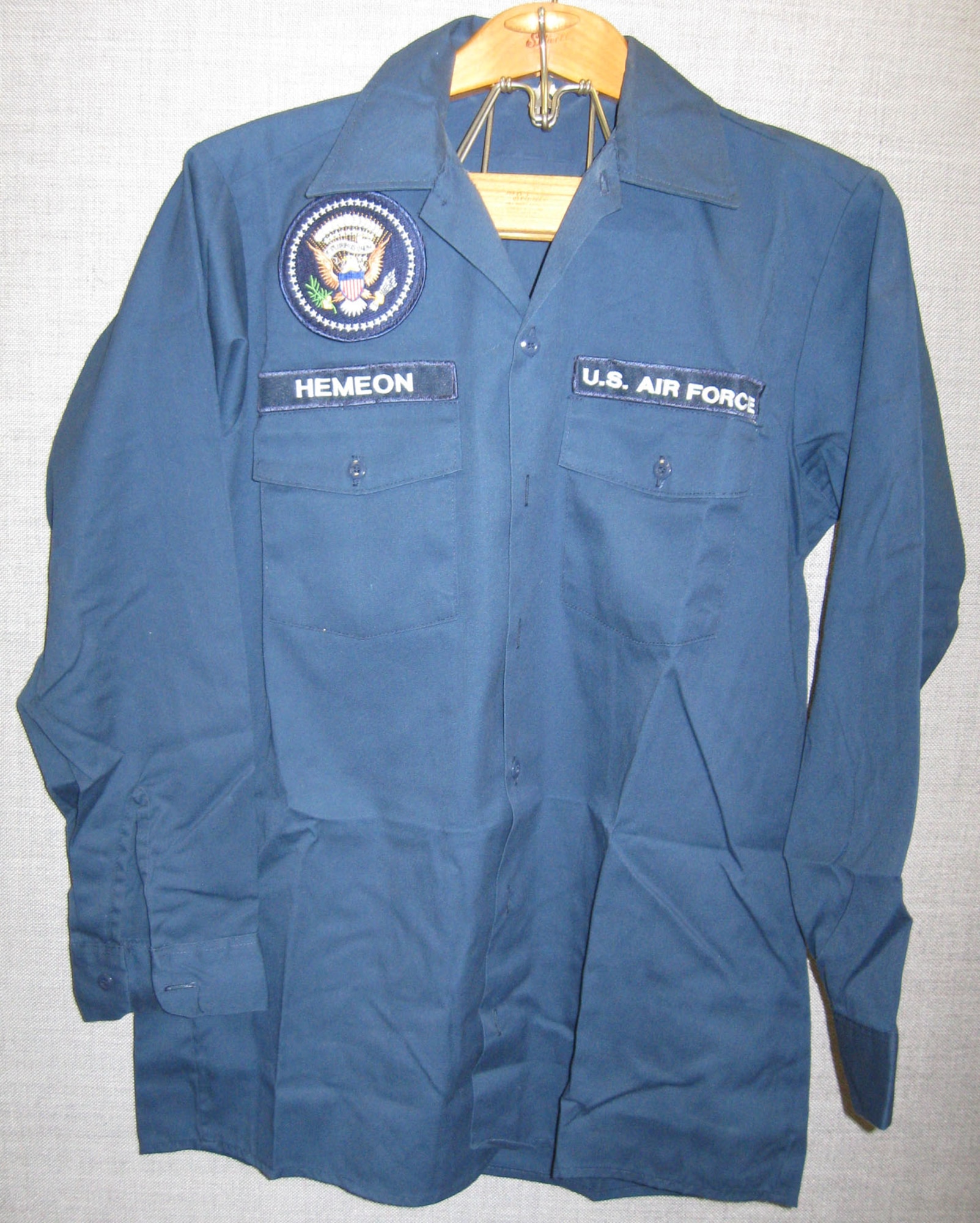 The donor of this blue long-sleeve maintenance shirt served 32 years in the Air Force, retiring on Aug. 1, 2006. He donated this item from his time as chief of maintenance for Air Force One from 1991-1994. (U.S. Air Force photo)