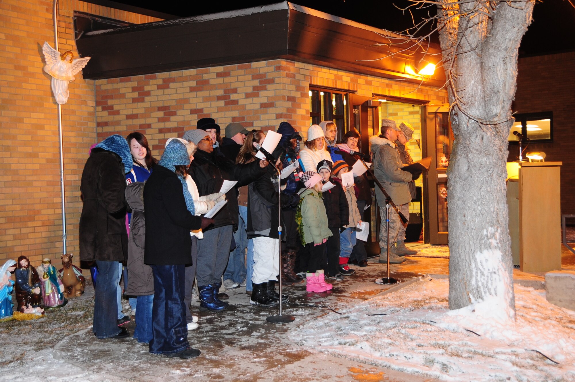 ELLSWORTH AIR FORCE BASE, S.D. -- The combined chapel choir sings "Oh, Christmas Tree" during the annual tree-lighting ceremony, Dec. 3.  In addition to the ceremony, children of Ellsworth Airmen enjoyed a visit from Santa Claus. (U.S. Air Force photo/Airman 1st Class Anthony Sanchelli)