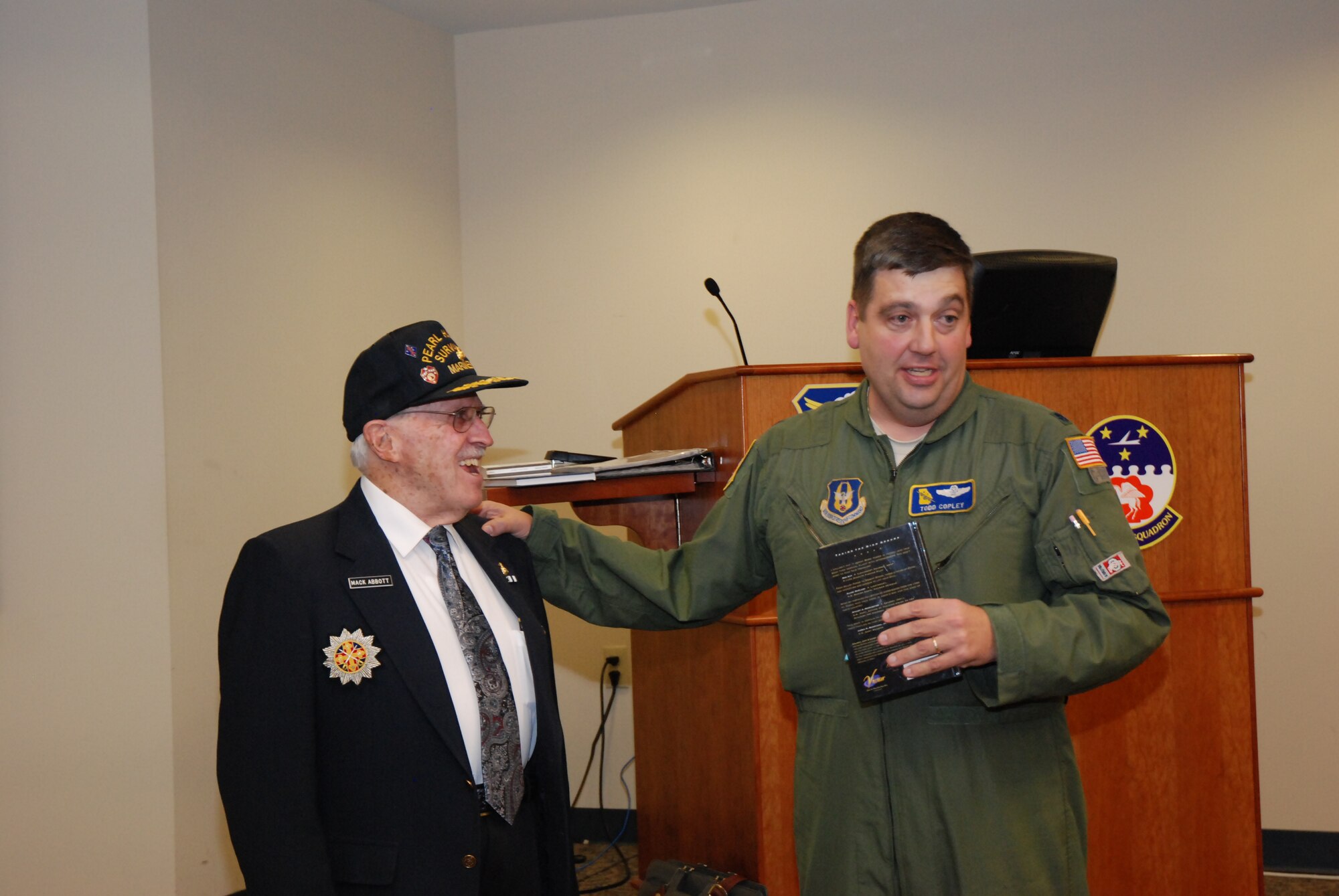 Lt. Col. Todd Copley, 700th Airlift Squadron, thanks Mr. Mack Abbott for sharing his World War II experiences.  

Mr. Abbott, a Pearl Harbor survivor, shared his experiences of the Pearl Harbor attack and his service in the Pacific during World War II to an audience of nearly 100 attendees—civilian and military. (U.S. Air Force photo/Master Sgt. Stan Coleman) 
