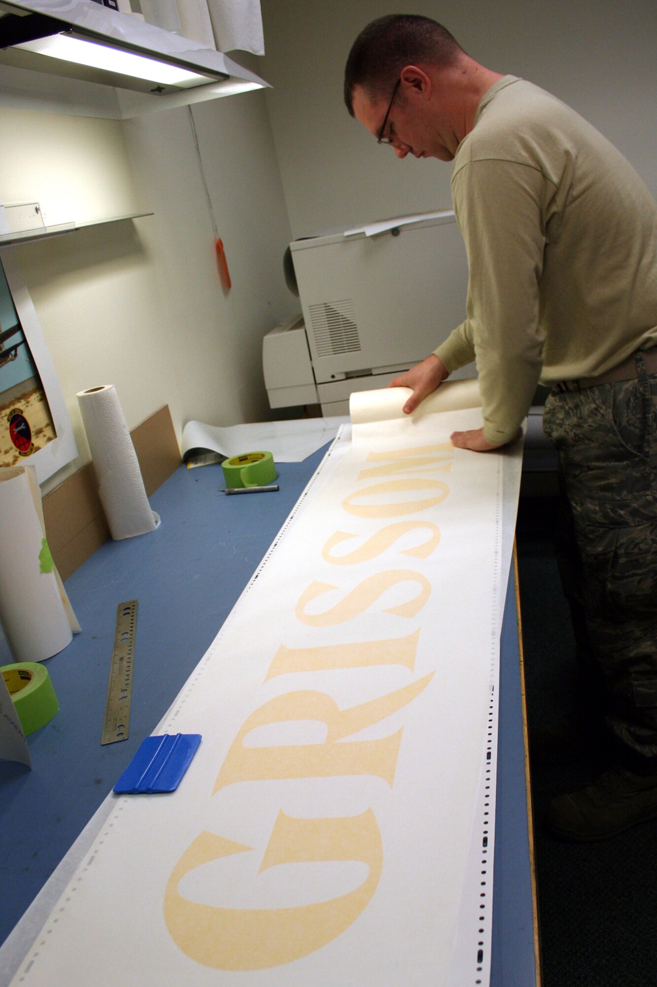 GRISSOM AIR RESERVE BASE, Ind., -- Tech. Sgt. Sean Kelly, an aircraft structural maintenance specialist with the 434th ARW Maintenance Squadron, prepares a decal "template" to be used in marking one of Grissom's stair trucks.  (Air Force photo/Staff Sgt. Chris Bolen)