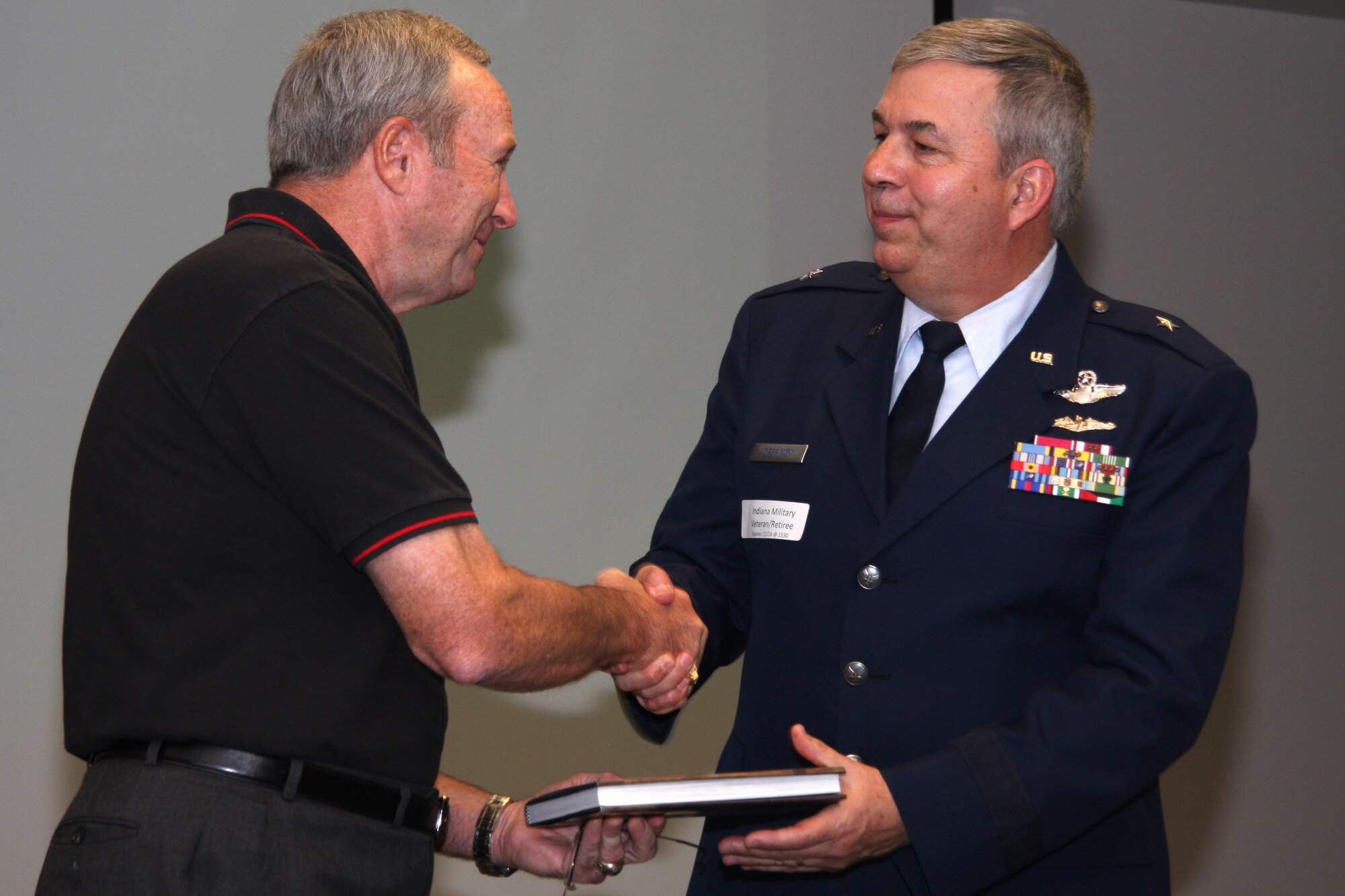 INDIANAPOLIS -- Retired Maj. Gen. Mark Pillar gives Brig. Gen. Dean Despinoy, 434th Air Refueling Wing commander,  a book as a token of appreciation for a presentation on Grissom ARB current events. General Despinoy gave the presentation to members of the Reserve Officers Association at a military appreciation day held at the Defense Finance and Accounting Service  in Indianapolis.   (U.S. Air Force photo/Tech. Sgt. Mark Orders-Woempner)