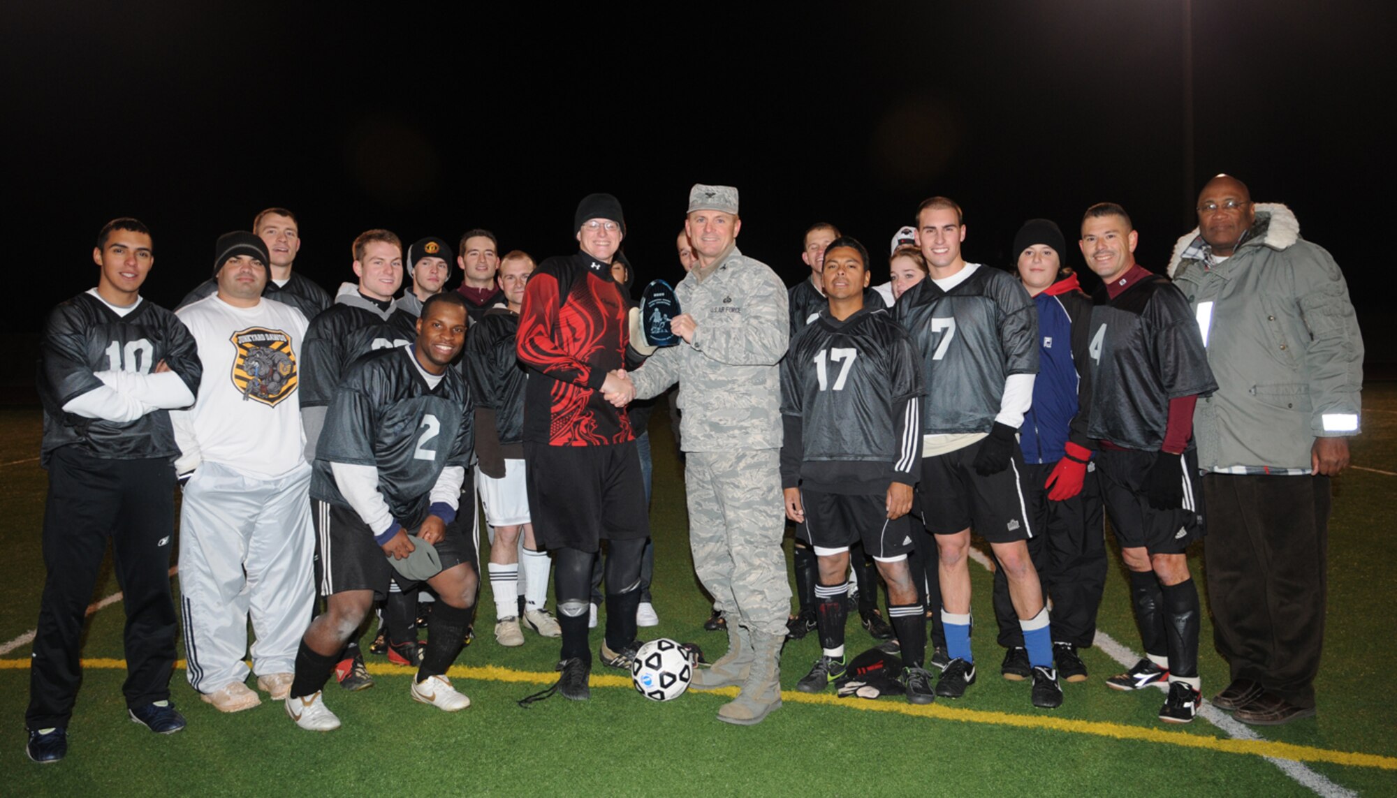 GOODFELLOW AIR FORCE BASE, Texas -- Col. Guy Parker, 17th Mission Support Group commander, presents the 1st place award to the 17th Mission Support Group Junk Yard Dogs at the football field, Dec. 3, 2009. The final score was 2-1. (U.S. Air Force photo/Airman Clayton Lenhardt)