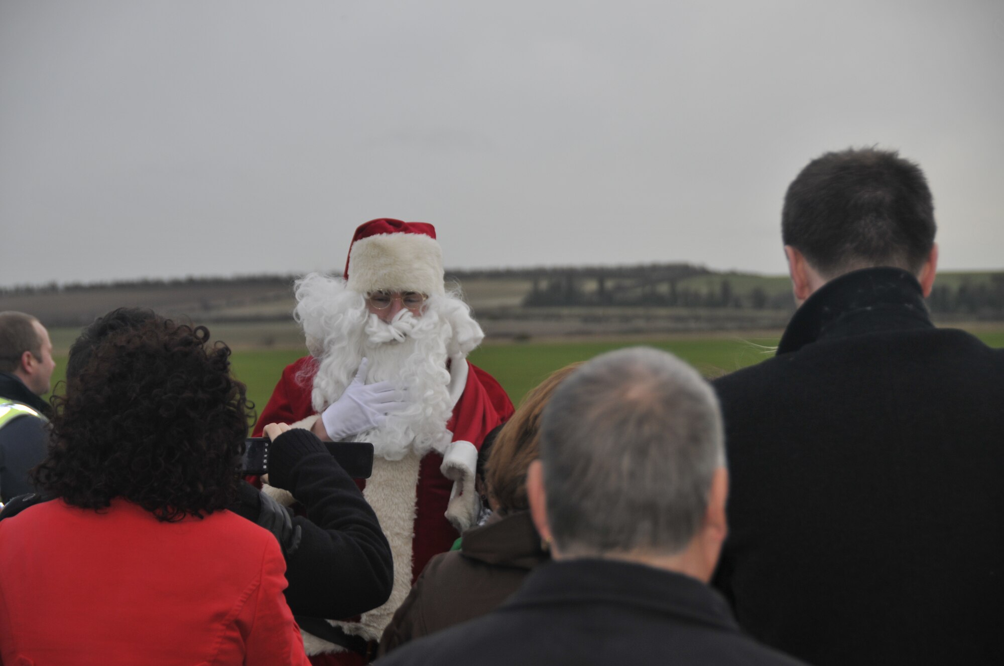 Santa Claus greets party goers at the Imperial War Museum at Duxford on Dec. 5. Volunteers from the 48th Fighter Wing hosted a party for terminally and seriously ill children at the museum. (Photo by Tech. Sgt. Chris Stagner)