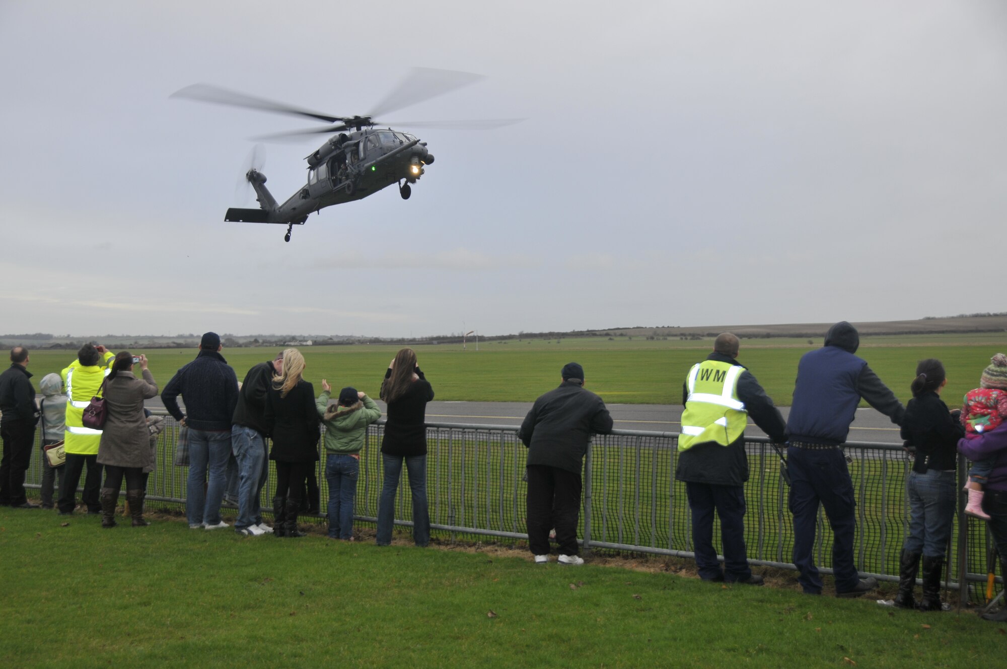 An HH-60G Pave Hawk from RAF Lakenheath, England, gives Santa Claus a ride to the Imperial War Museum at Duxford on Dec. 5. Volunteers from the 48th Fighter Wing hosted a party for terminally and seriously ill children at the museum. (Photo by Tech. Sgt. Chris Stagner)