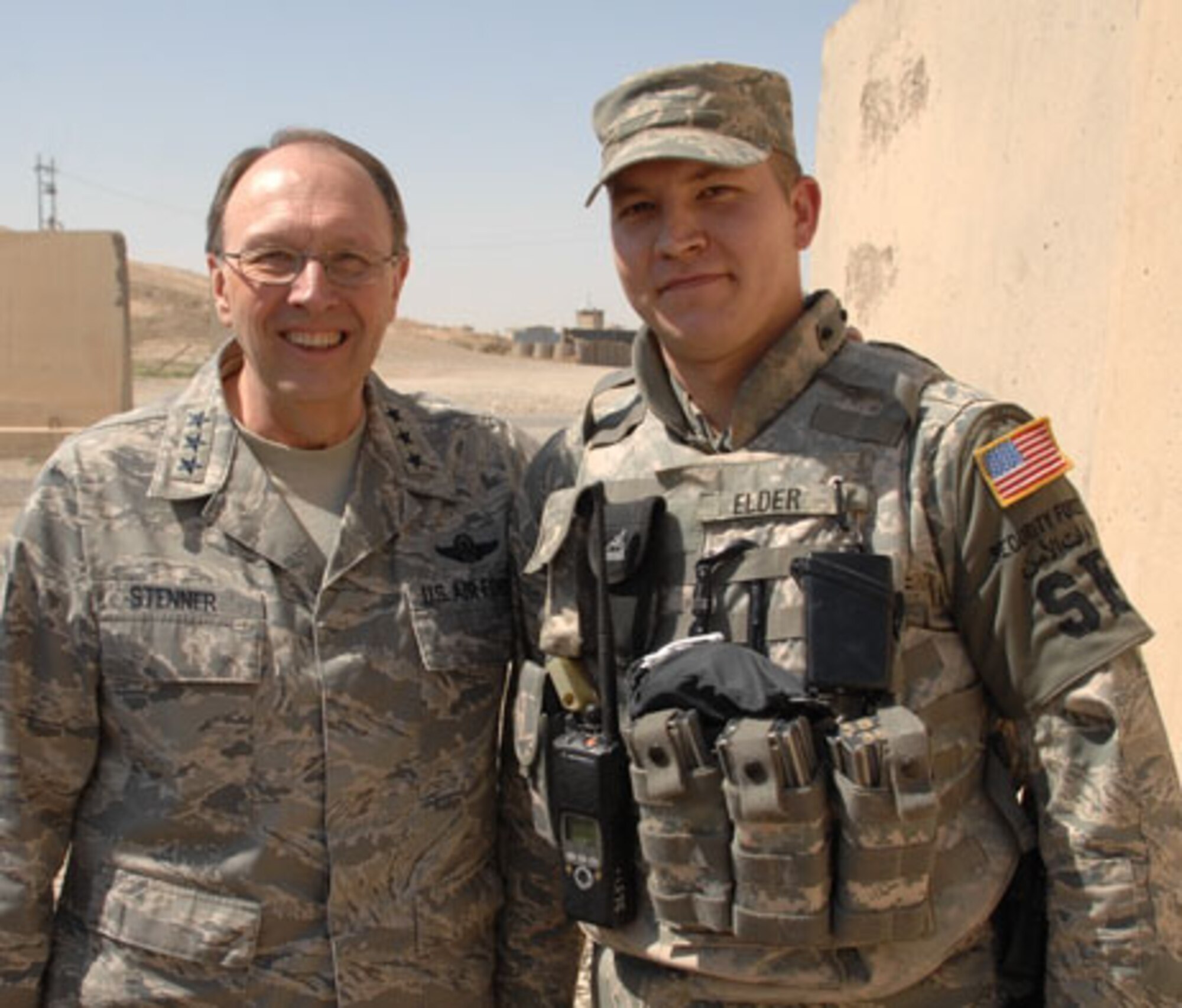 During a visit with the troops in April 2009, Lt. Gen. Charles E. Stenner Jr., commander of Air Force Reserve Command, poses for a photo with Tech. Sgt. Lawrence J. Elder, a security forces Airman deployed to Iraq from the 315th Airlift Wing, Charleston Air Force Base, S.C. In his 2009 holiday season message, the general urges people to remember the men and women who are away from home defending freedom. (U.S. Air Force photo)