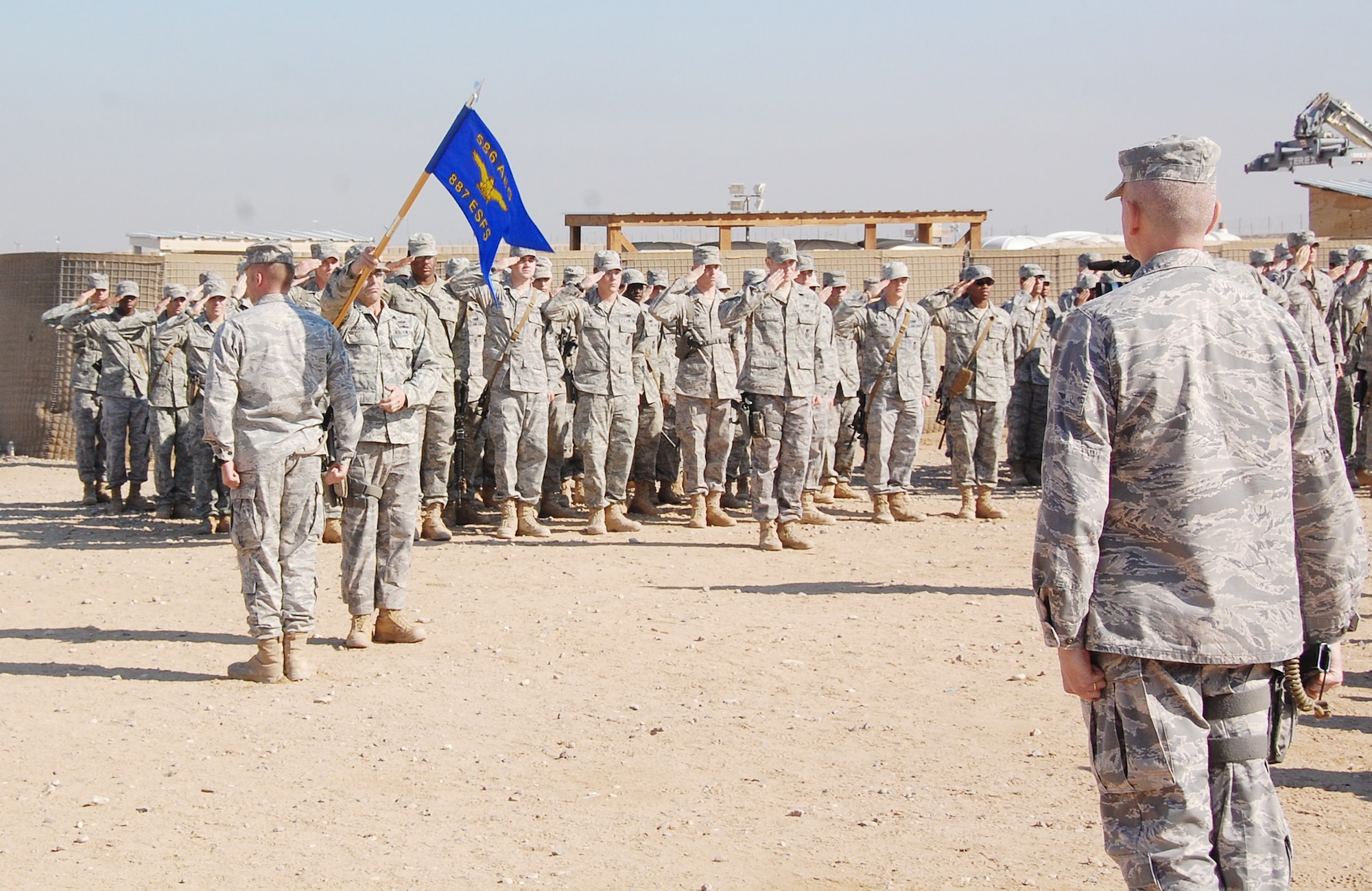 Members of the 887th Expeditionary Security Forces Squadron render their final salute to Maj. Larry Wood during the 887th ESFS deactivation ceremony Dec. 3, 2009 at Camp Bucca, Iraq. Major Wood is the 887th ESFS commander. (U.S. Air Force photo/Staff Sgt. Shaun Emery)