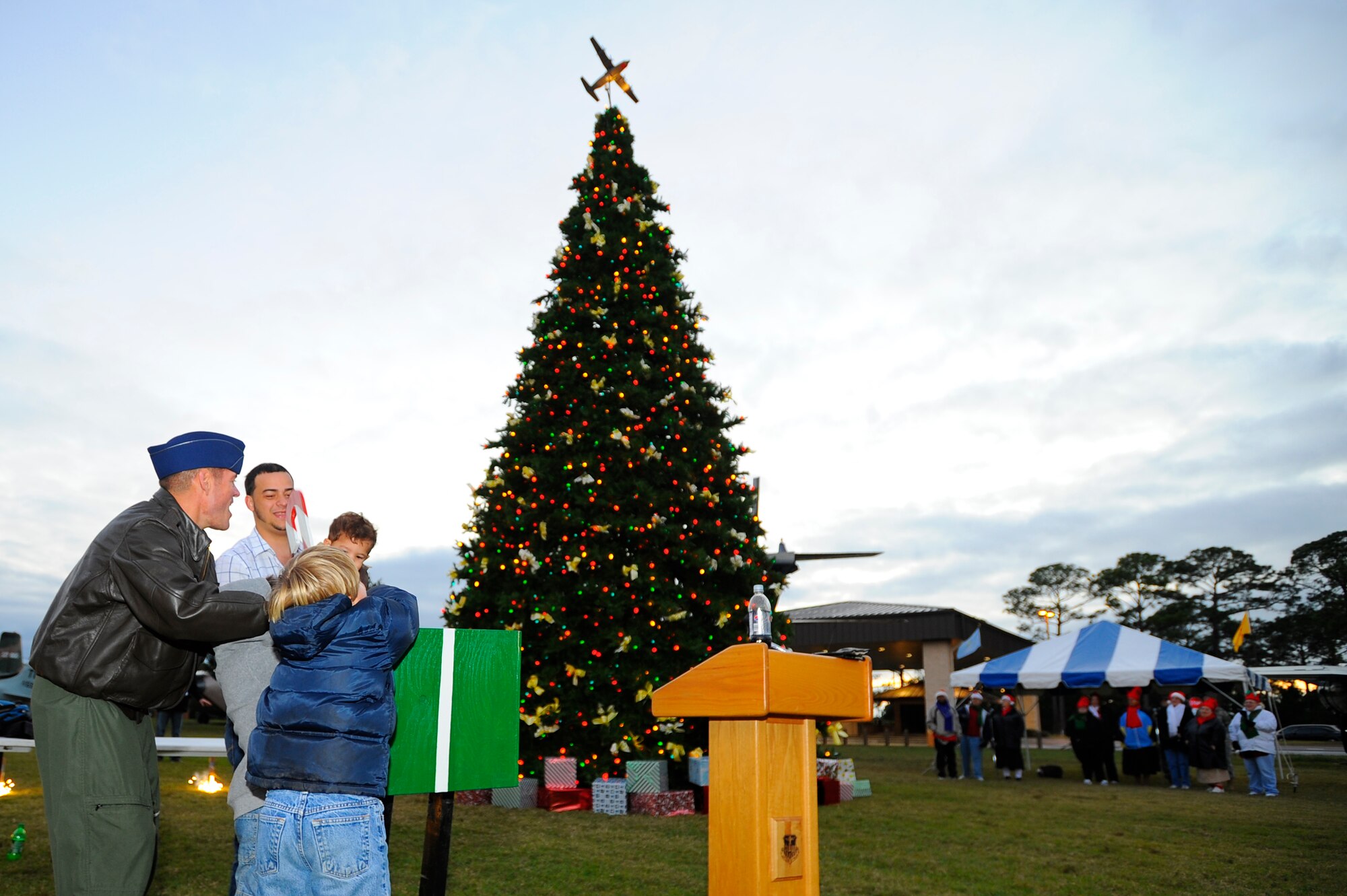 Col. Ben McMullen, acting 1st Special Operations Wing vice commander, helps children pull the switch to activate the lights during the Hurlburt Holiday Tree Lighting at the Air Park Dec. 3. The ceremony also included pyrotechnics, caroling and an appearance by Santa Claus. (Air Force photo by Senior Airman Jason Epley)  