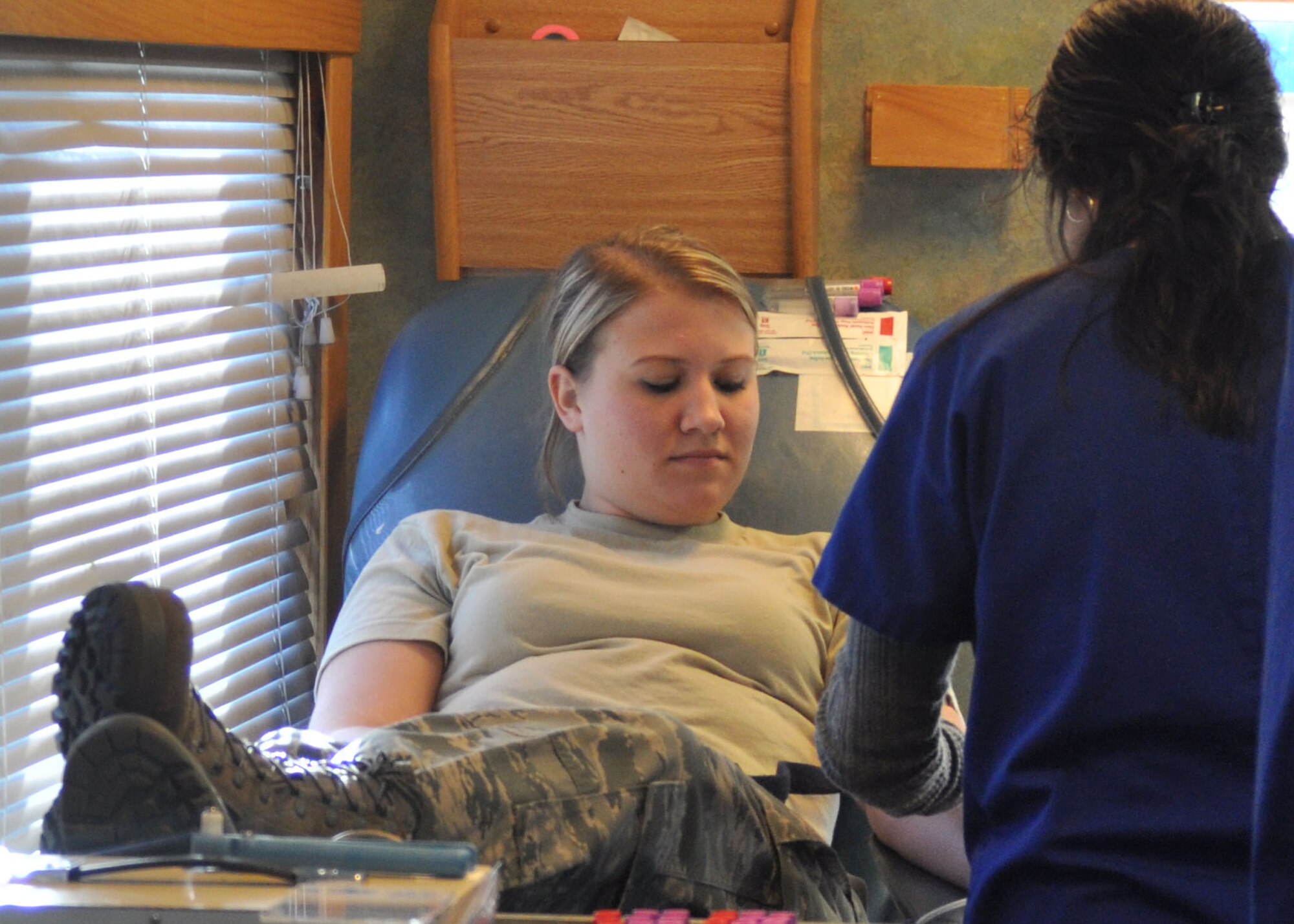 Airman Basic Molly Bagley, a travel management technician for the 917th Wing on Barksdale Air Force Base, La., looks on as she’s prepped by a LifeShare Blood Centers nurse in Shreveport, La., during an on-base blood drive December 6, 2009 in the parking lot of the 917th Headquarters building. By donating blood, Airman Bagley aided in efforts to reach a 20-unit quota in the four hours the blood drive took place at the 917th Wing.  (U.S. Air Force photo/Senior Airman Crystal Jordan)