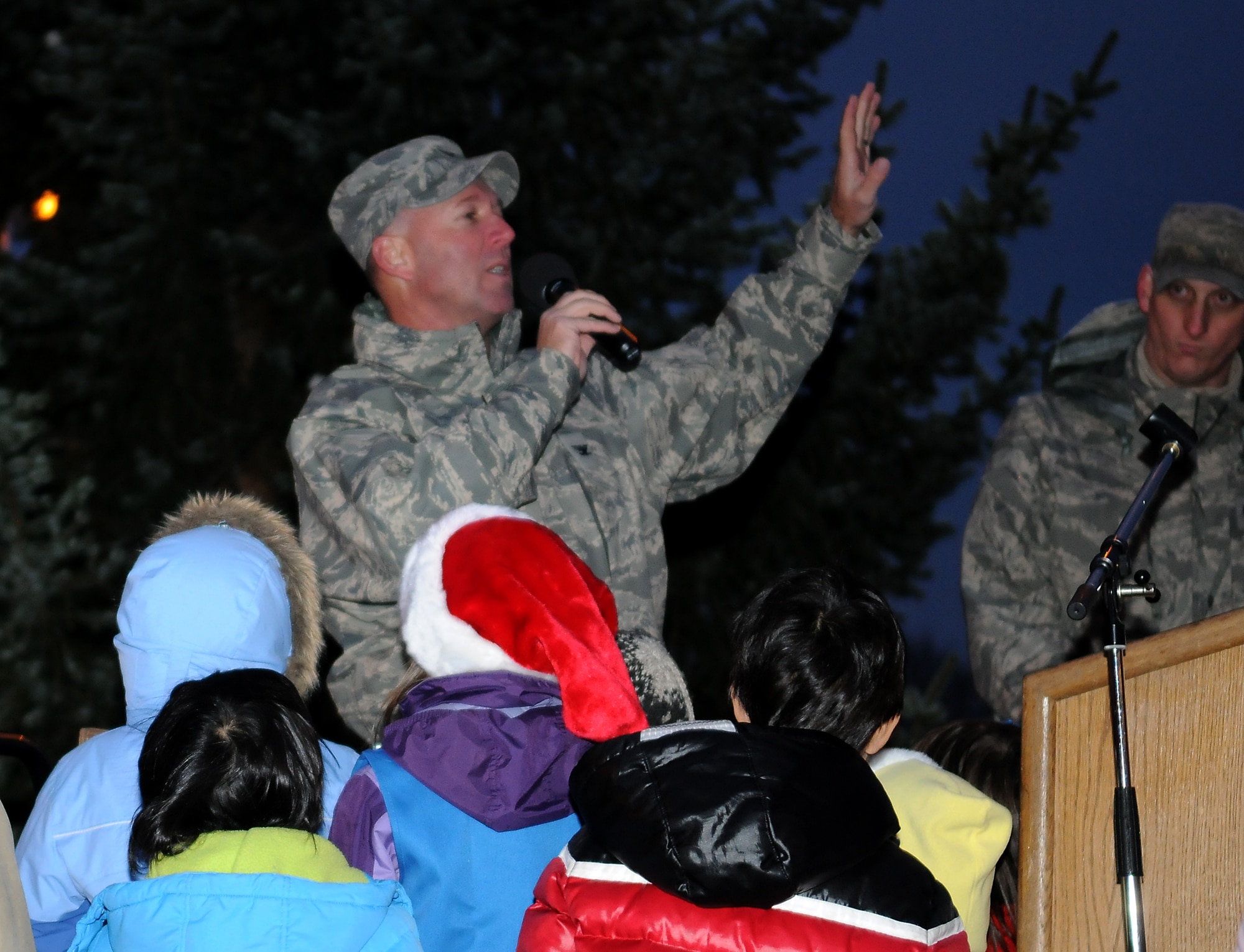 SPANGDAHLEM AIR BASE, Germany -- Col. Tip Wight, 52nd Fighter Wing commander, leads the countdown to the lighting of the Spangdahlem Air Base holiday tree Dec. 4. Members of the 52nd FW participated in the holiday festivities by singing songs and enjoying cookies and hot cocoa after the tree lighting. (U.S. Air Force photo/Airman 1st Class Nathanael Callon)