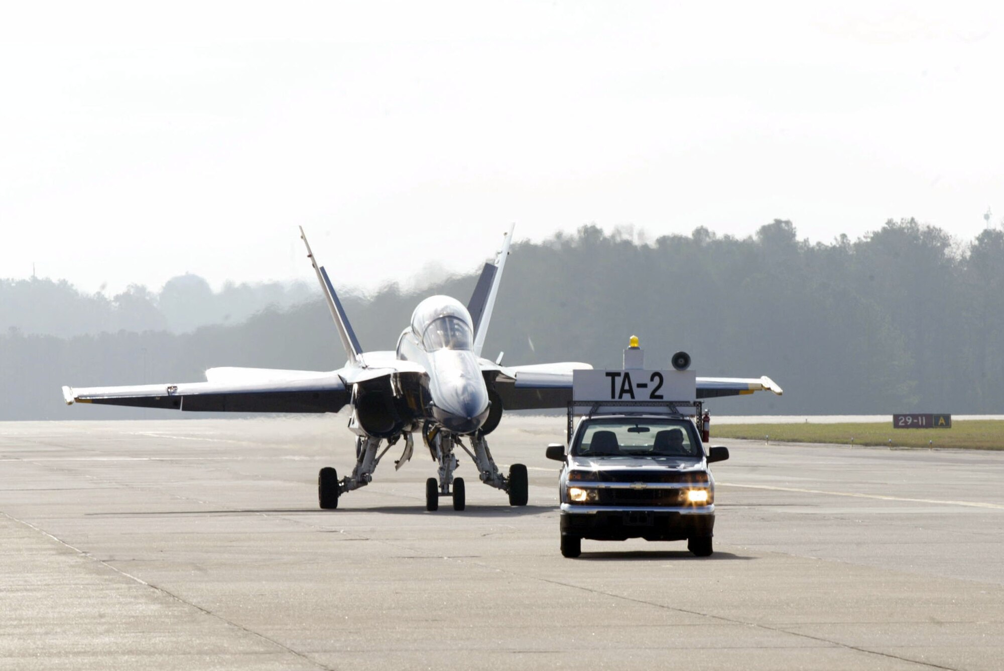 A Blue Angels F/A-18 Hornet aircraft arrives to Dobbins Air Reserve Base Dec. 4. Navy Lts. C.J. Simonsen, No. 7 pilot and narrator, and Amy Tomlinson, events coordinator, visited the base to conduct a site visit in preparation for the 2010 "Wings Over Atlanta" air show. The Blue Angels and Canadian Snowbirds are scheduled to be the headliners during the show Oct. 16-17. (U.S. Air Force photo/Don Peek)