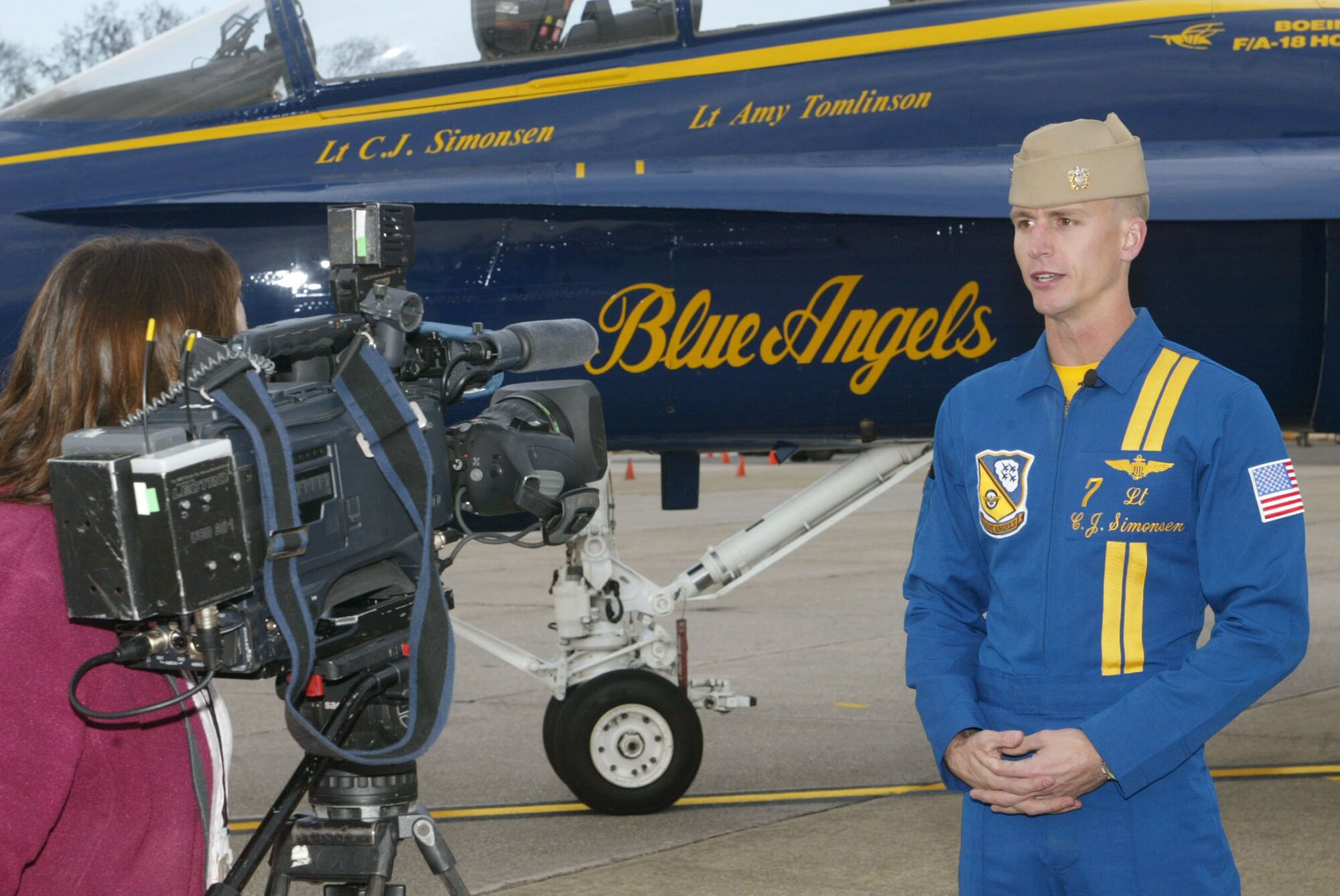 Navy Lt. C.J. Simonsen, No. 7 Blue Angels pilot and narrator, talks to a reporter in front of his F/A-18 Hornet aircraft after arriving to Dobbins Air Reserve Base Dec. 4. Lieutenant Simonsen along with Navy Lt. Amy Tomlinson, Blue Angels events coordinator, visited the base to conduct a site visit in preparation for the 2010 "Wings Over Atlanta" air show. The Blue Angels and Canadian Snowbirds are scheduled to be the headliners during the show Oct. 16-17. (U.S. Air Force photo/Don Peek)
