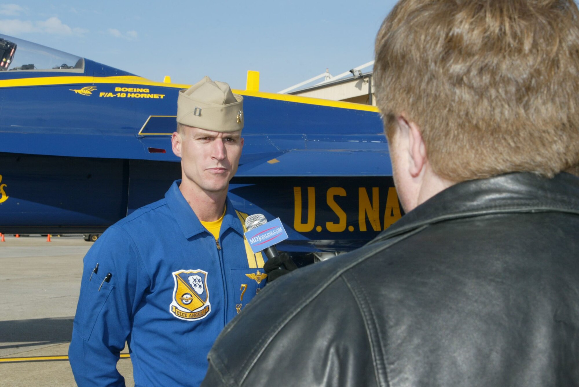 Navy Lt. C.J. Simonsen, No. 7 Blue Angels pilot and narrator, talks to a reporter in front of his F/A-18 Hornet aircraft after arriving to Dobbins Air Reserve Base Dec. 4. Lieutenant Simonsen along with Navy Lt. Amy Tomlinson, Blue Angels events coordinator, visited the base to conduct a site visit in preparation for the 2010 "Wings Over Atlanta" air show. The Blue Angels and Canadian Snowbirds are scheduled to be the headliners during the show Oct. 16-17. (U.S. Air Force photo/Don Peek)
