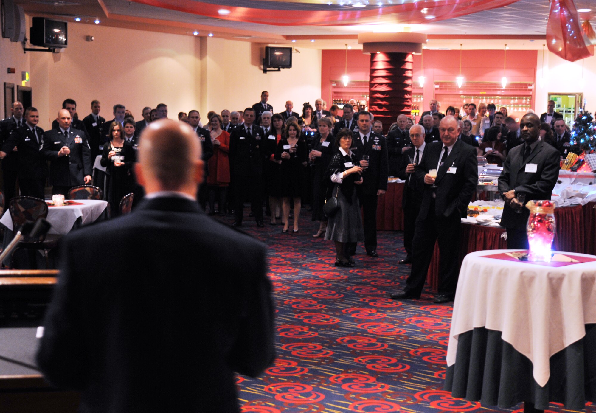 Col. Chad Manske, 100th Air Refueling Wing commander, welcomes dozens of distinguished visitors from East Anglia to a Yuletide reception held at The Galaxy Club Dec. 4. The DVs met with RAF Mildenhall leadership for the annual event. (U.S. Air Force photo/Tech. Sgt. Kevin Wallace)