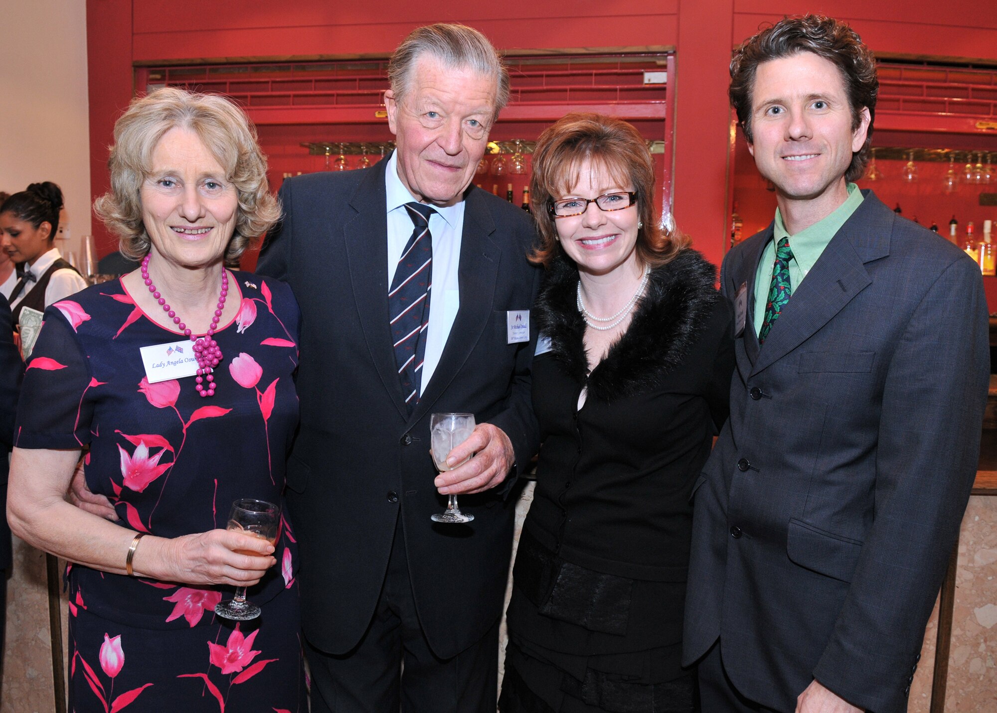 Dozens of distinguished visitors from East Anglia met with RAF Mildenhall leadership for an annual Yuletide reception at The Galaxy Club Dec. 4. Receptions such as this are vital to foster ongoing community relations. Lady Angela Oswald, 6th Marquess of Exeter; Sir Michael Oswald, 100th Air Refueling Wing honorary commander and former advisor to the Queen; Laura Kunkle, a 48th Fighter Wing contracting officer; and Taylor Kunkle, British-American Community Relations Committee member, gather for a photograph during the Yuletide event. (U.S. Air Force photo/Tech. Sgt. Kevin Wallace)